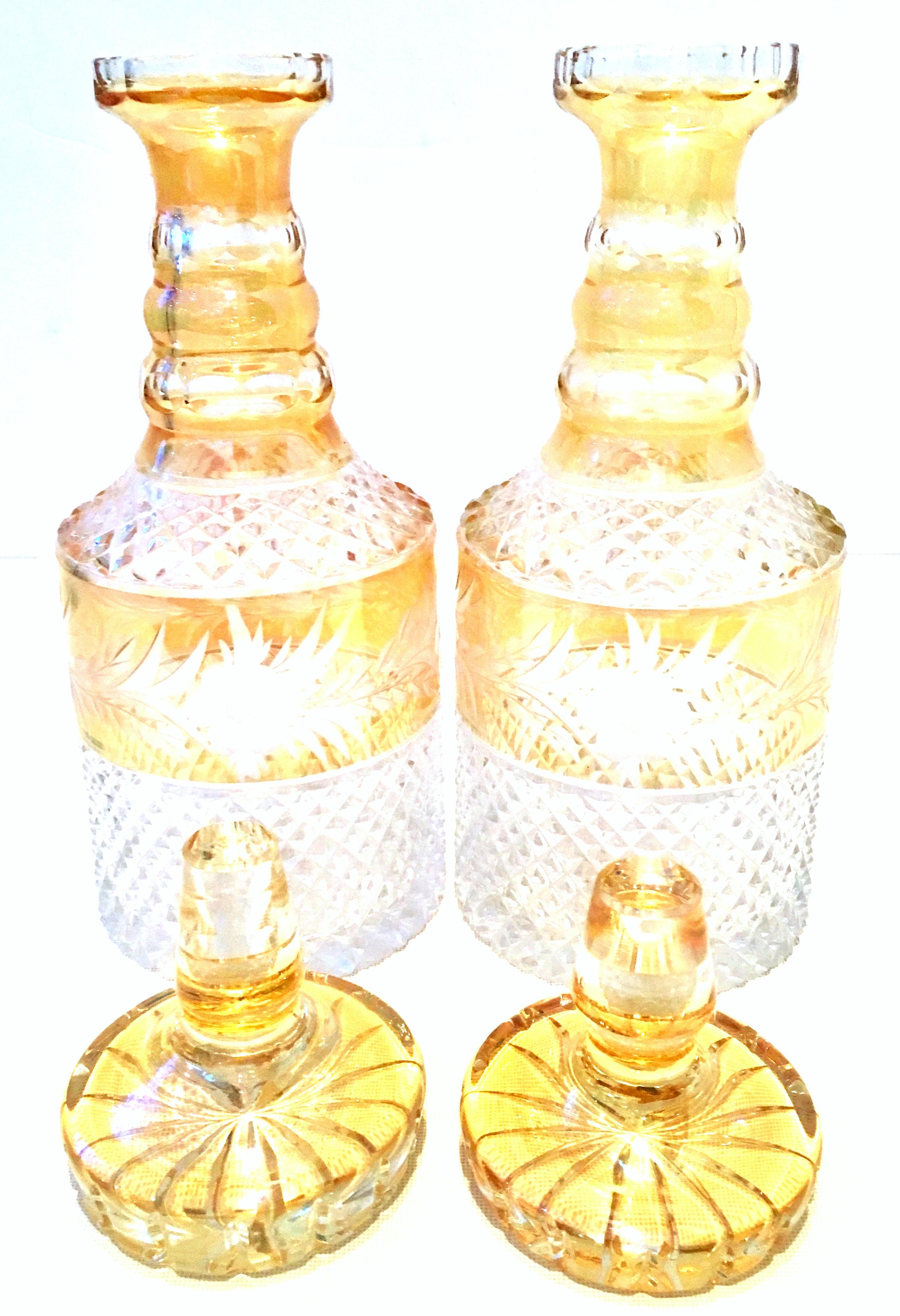 Mid-20th century pair of Bohemia cut crystal liquor decanter's. Features a diamond cut pattern with citrine color and etched floral pattern.