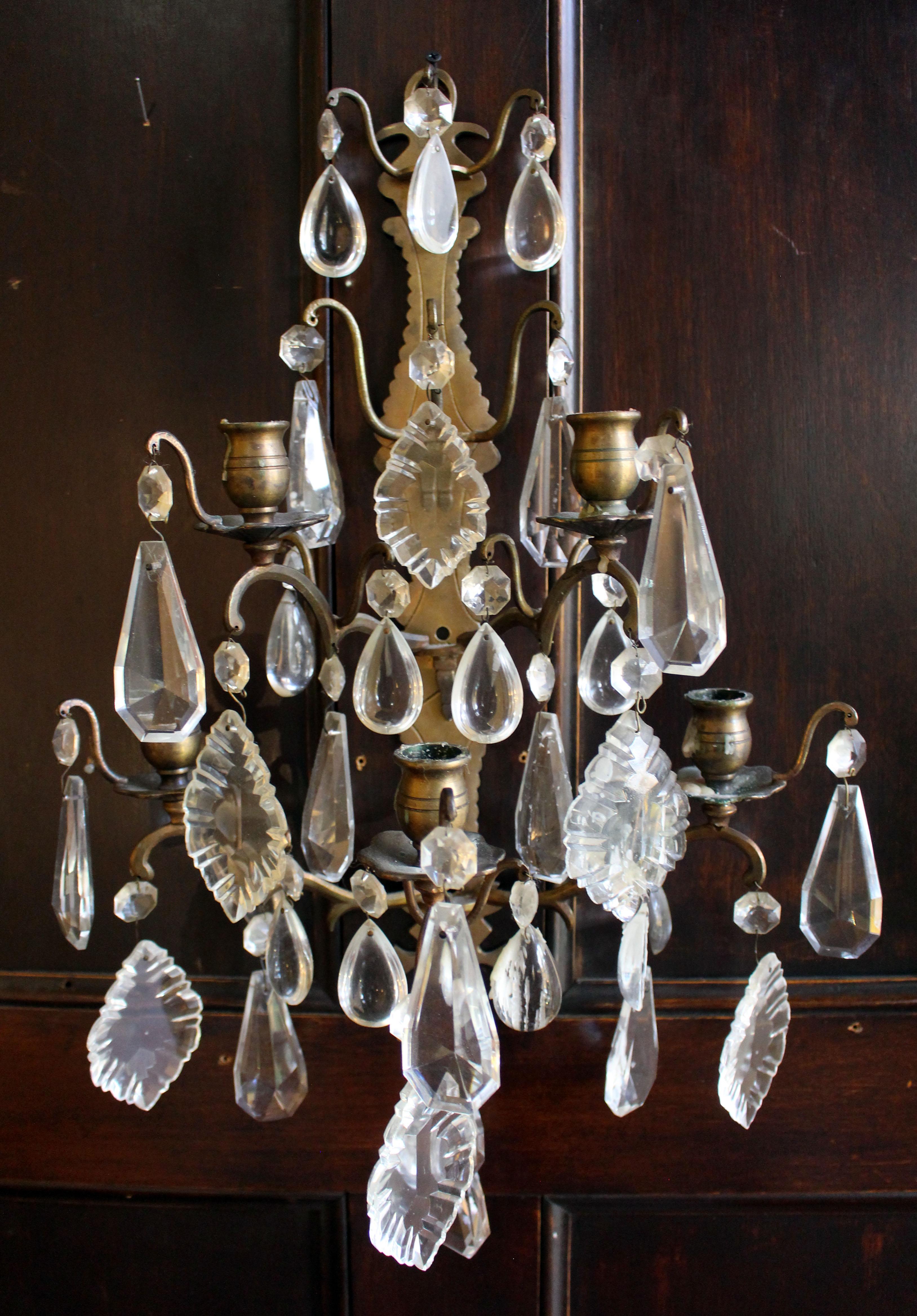 Mid-20th century pair of 5-light wall sconces, French. Engraved, cut bronze with optic, panel cut & French cut glass prisms. Fine overall condition. Not electrified, could likely be French wired. Backplate is 17 5/8