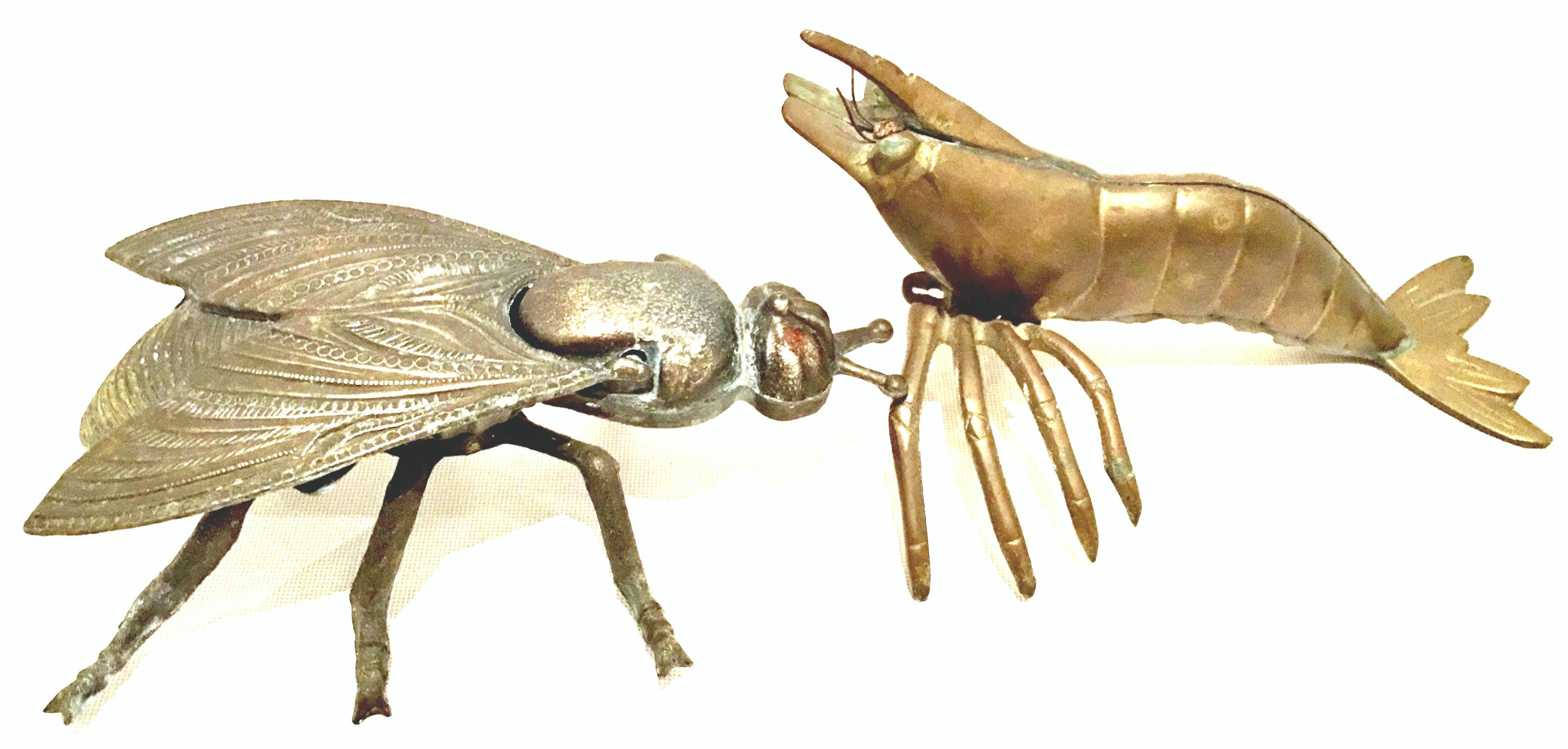Mid-20th century Art Nouveau pair of iron and brass figural fly and shrimp sculpture & box. The Fly box made of cast iron features a hinged lid. The weighted brass shrimp features attached legs and wire articulating eye detail.
The hinged fly box