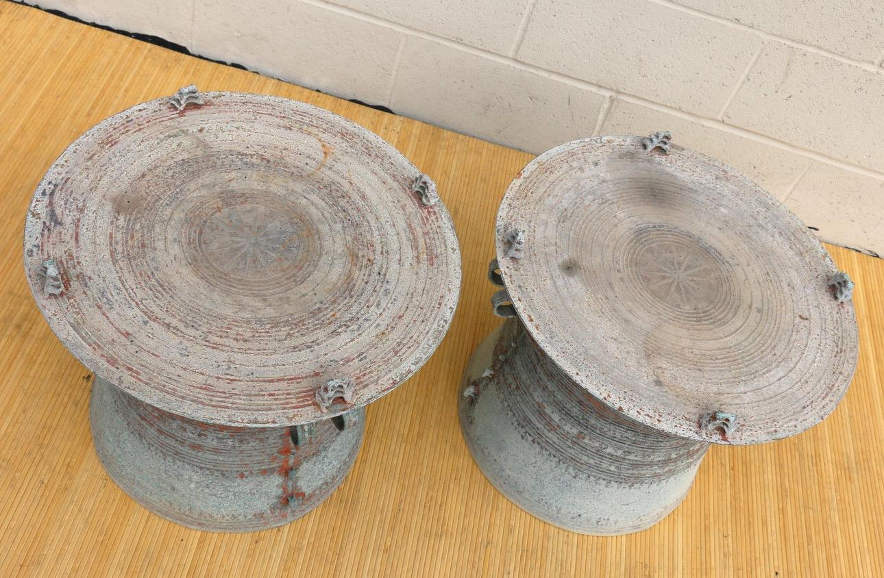 Awesome pair of Southeast Asian rain drum side tables made of bronze. They are absolutely gorgeous, they have a lot of great features, including two elephants going down. These side tables are very heavy and sturdy. They are in good vintage