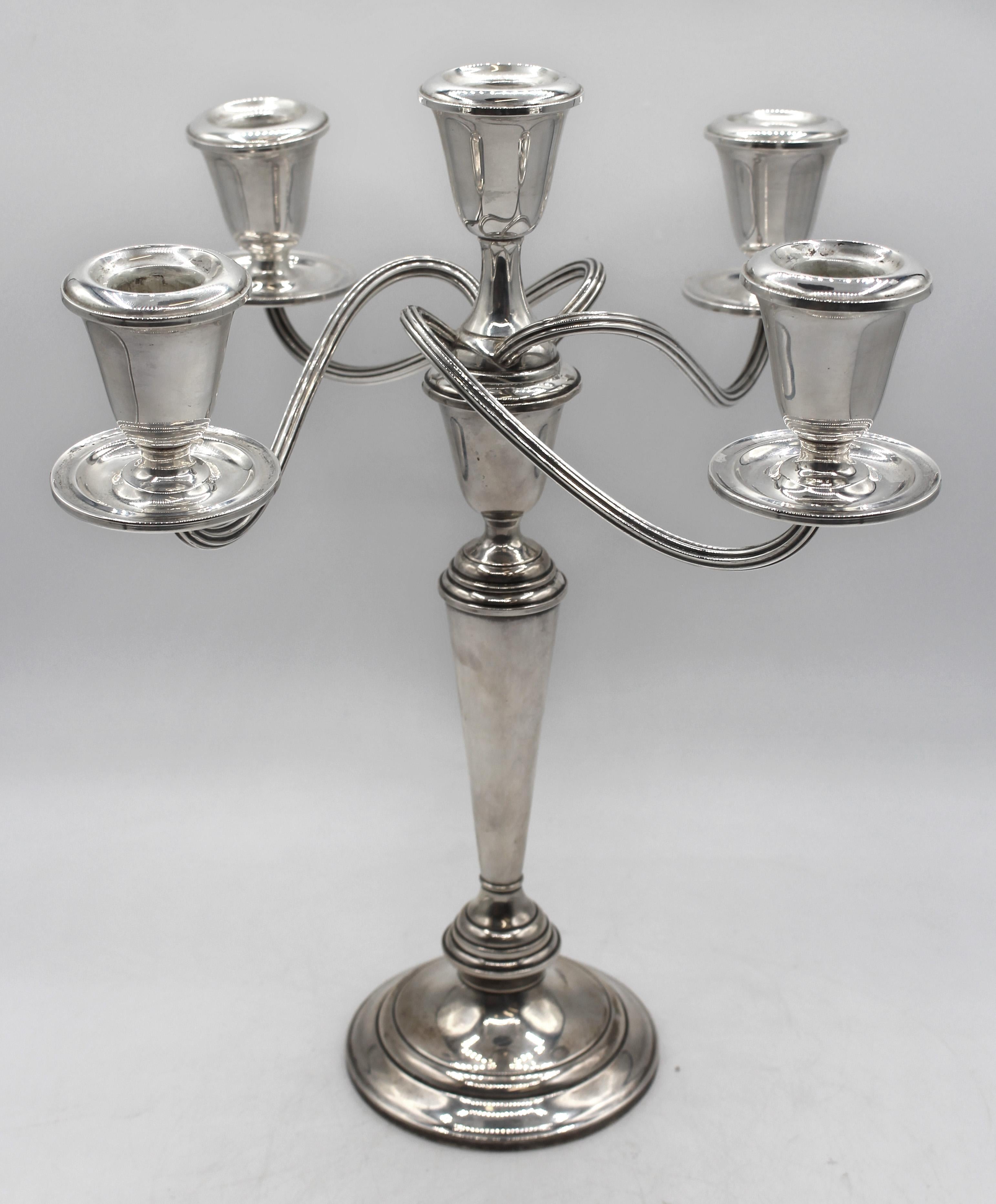 Mid-20th century pair of sterling silver 5-light candelabras by Newport Silver Co. Made in four sections for various functions. Minor bends & one soccle loose.
12.5
