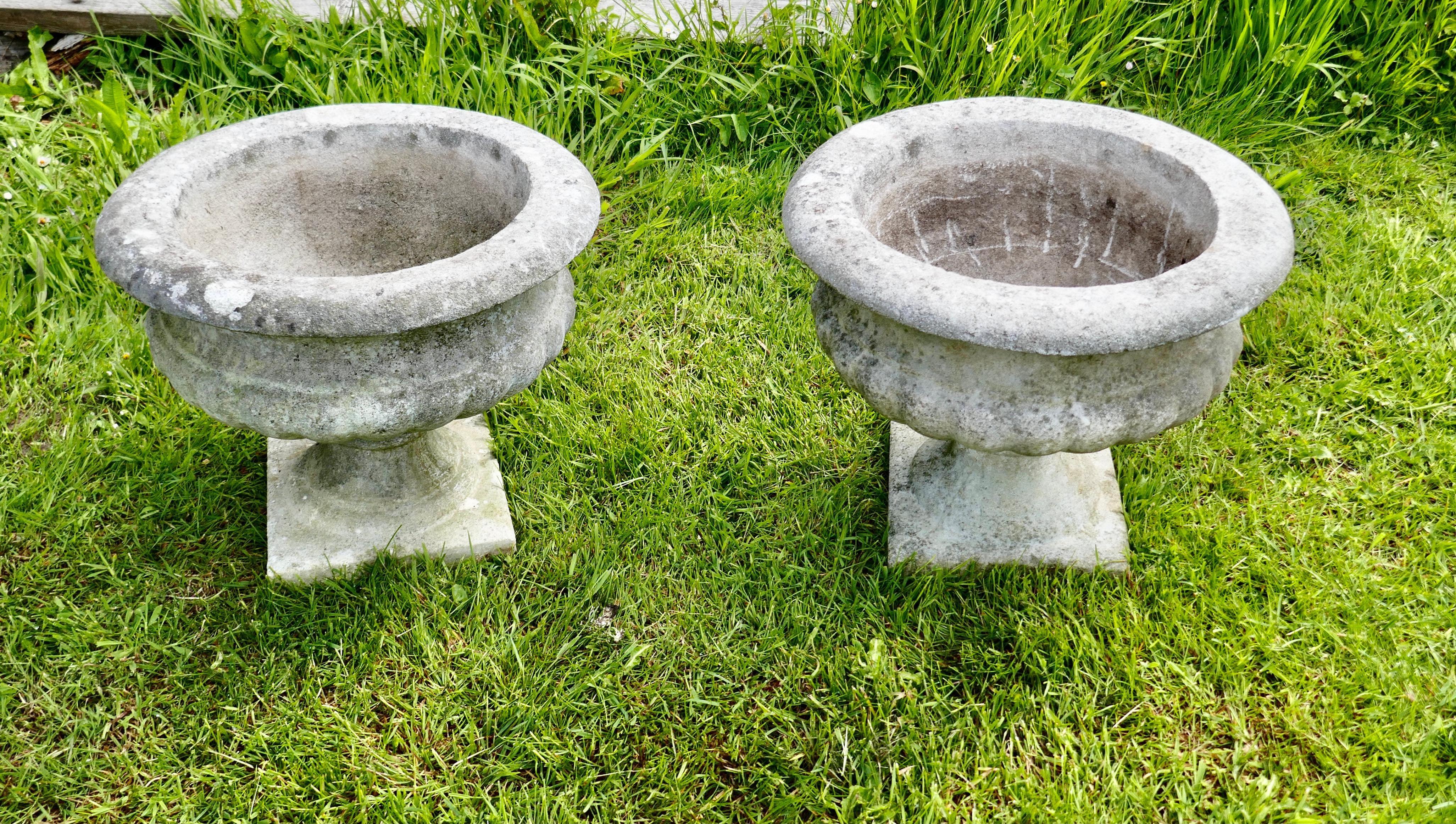 Mid 20th century pair of weathered cast stone garden planters

A good pair of 20th century planters, they are well weathered and have a drainage hole in the centre
In good sound condition, very heavy, they are 15” high, 18” in diameter, the
