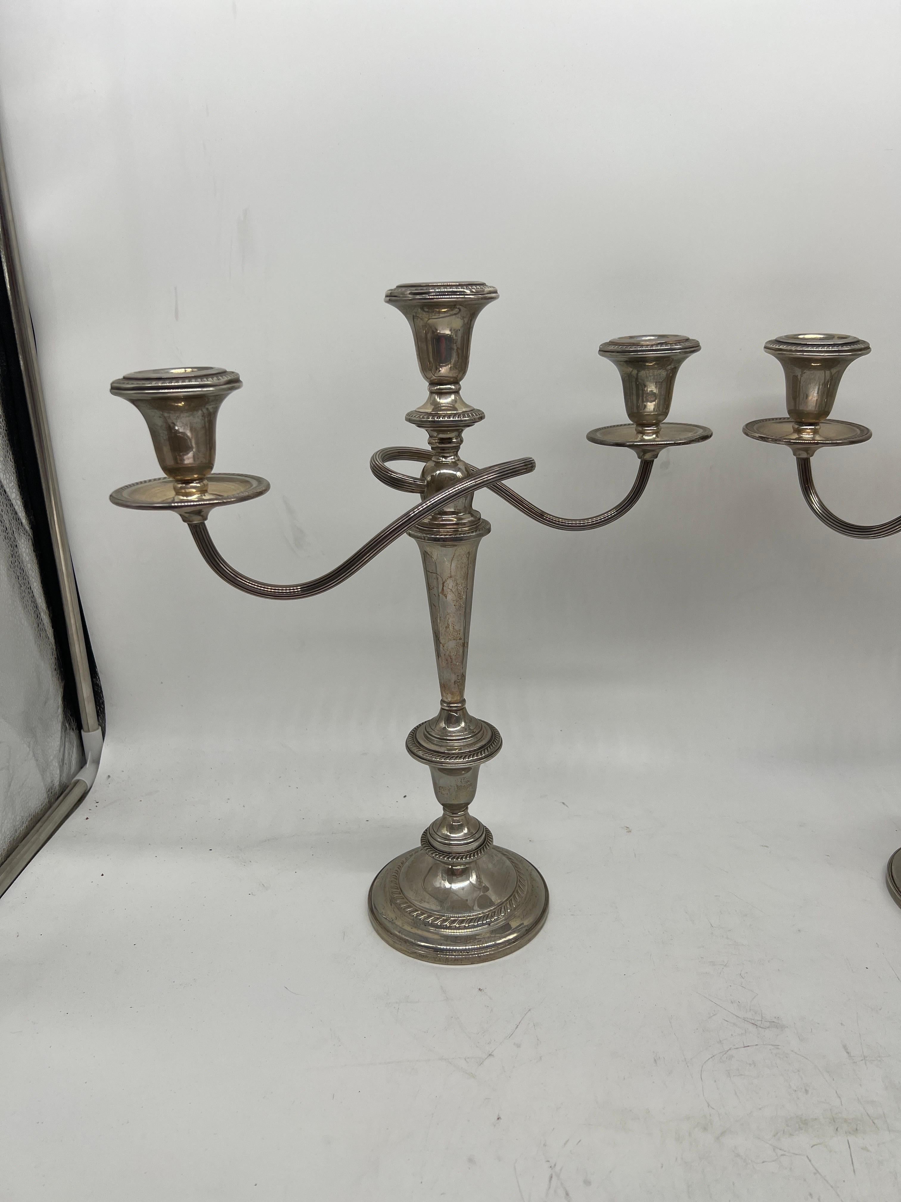 Mid-20th Century Pair of Weighted, Sterling Convertible, Three Light Candelabra, Hamilton silversmith makers, with gadrooned rims, thistle sconces, reeded bypass candle arms, tapering cylindrical stem and domed foot. Each piece appropriately marked.