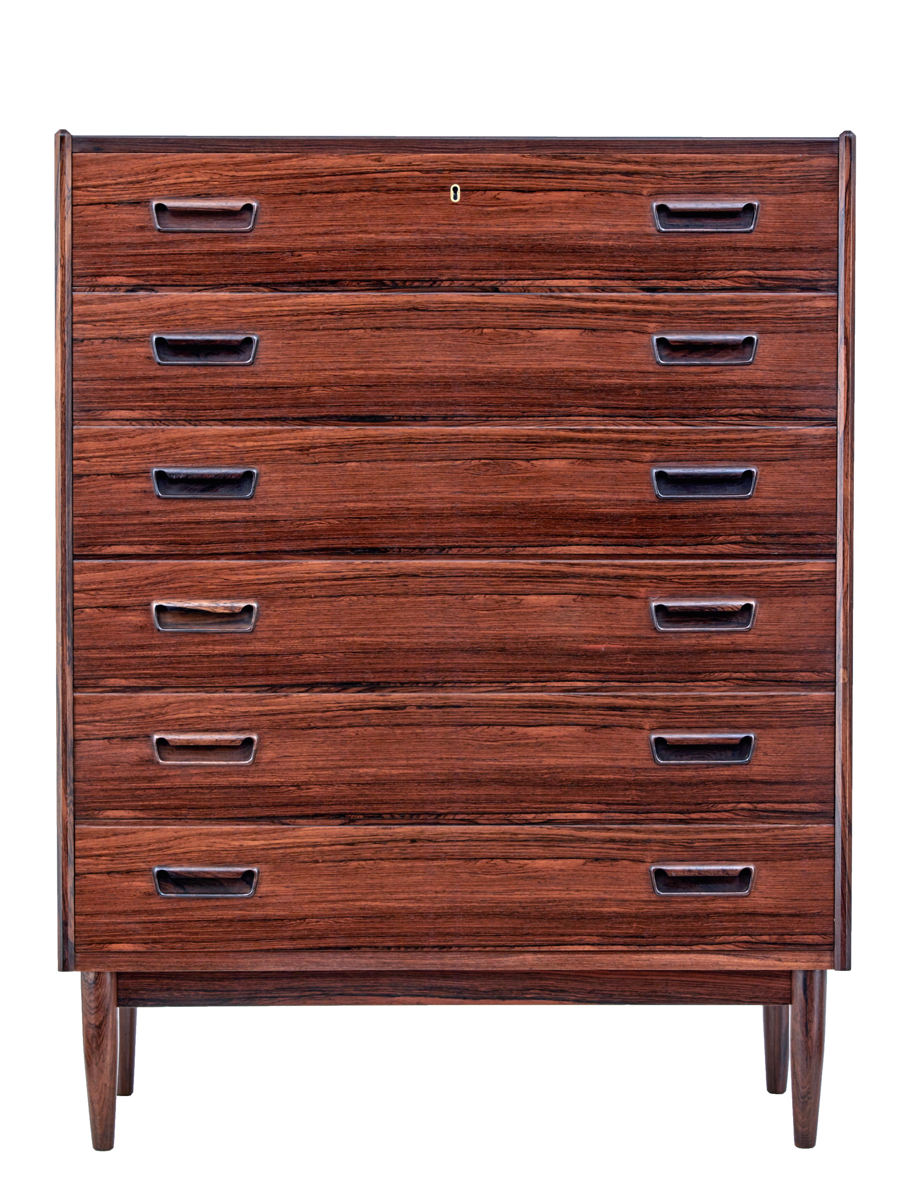 Mid-20th century palisander tall chest of drawers, circa 1960.

Good quality Scandinavian tall chest of drawers. 6 equal sized drawers with fitted solid handles.

Striking veneers used, with rich color. Standing on tapered legs.

Minor loss to