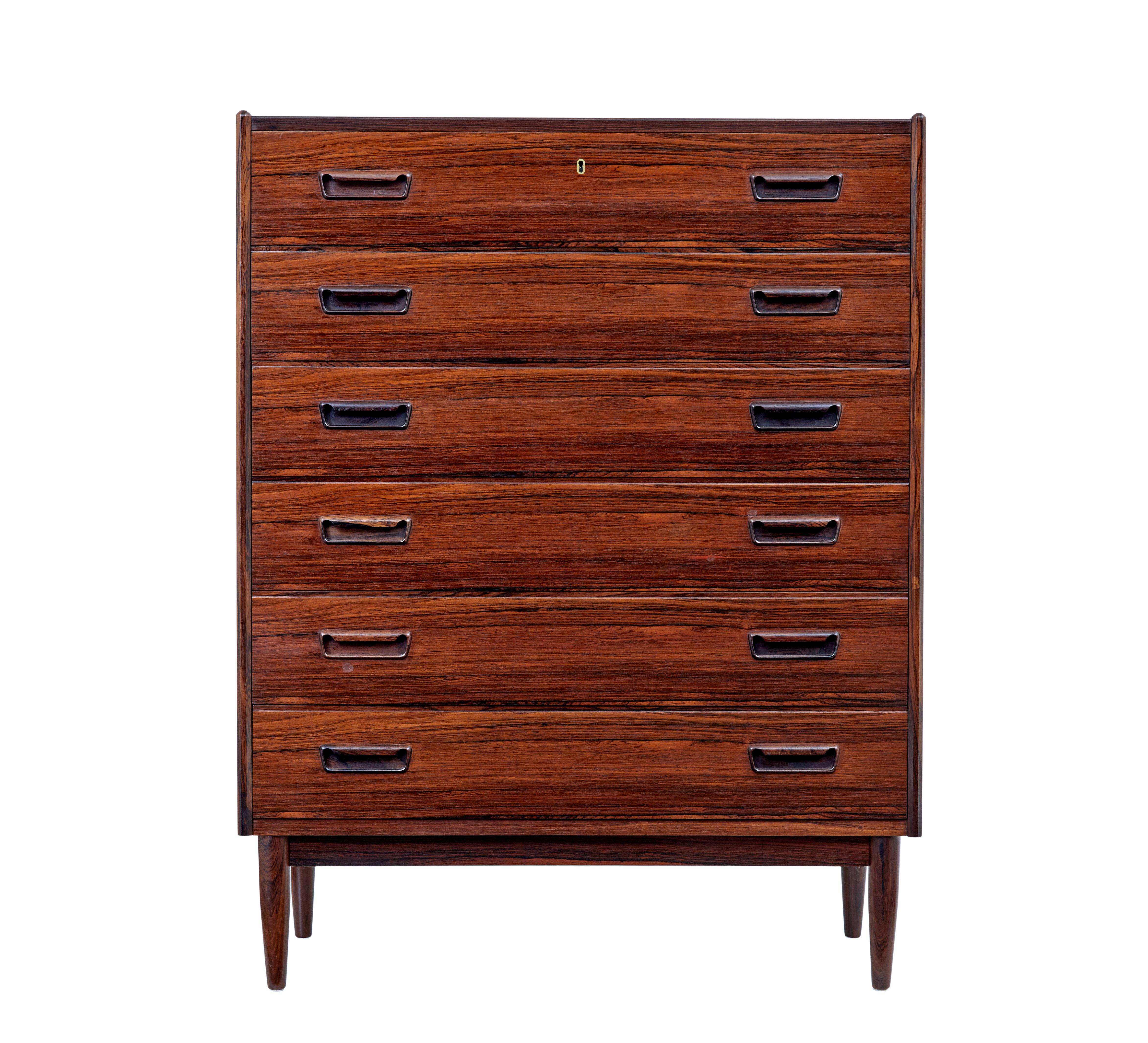 Mid 20th century palisander tall chest of drawers circa 1960.

Good quality Scandinavian tall chest of drawers.  6 equal sized drawers with fitted solid handles, top drawer fitted with a lock.

Striking veneers used, with rich colour.  Standing