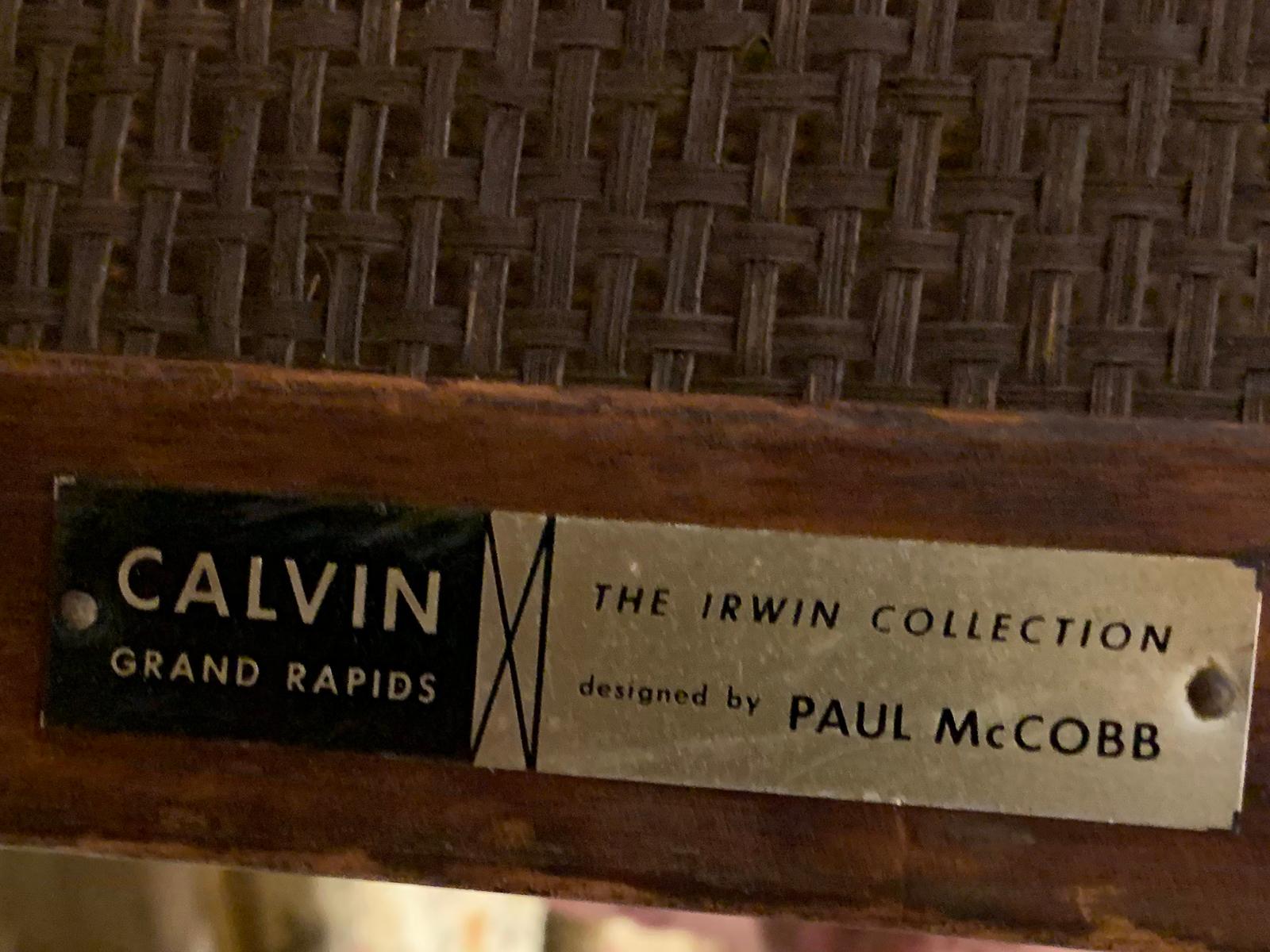 Mid-20th century Paul McCobb three-tier table, leather top, cane shelves, marked
Designed by Paul McCobb for the Irwin collection, Calvin, Grand Rapids.
 