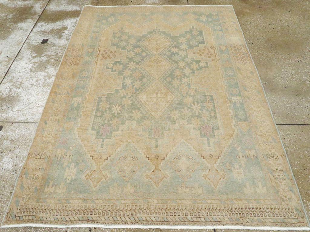 A vintage Persian Afshar accent rug. On a pale blue-grey ground, the buff sub-field displays three pointed, cross-topped finials at each end, and contains a deeply notched and stepped slate-blue cartouche featuring a central three diamond pole