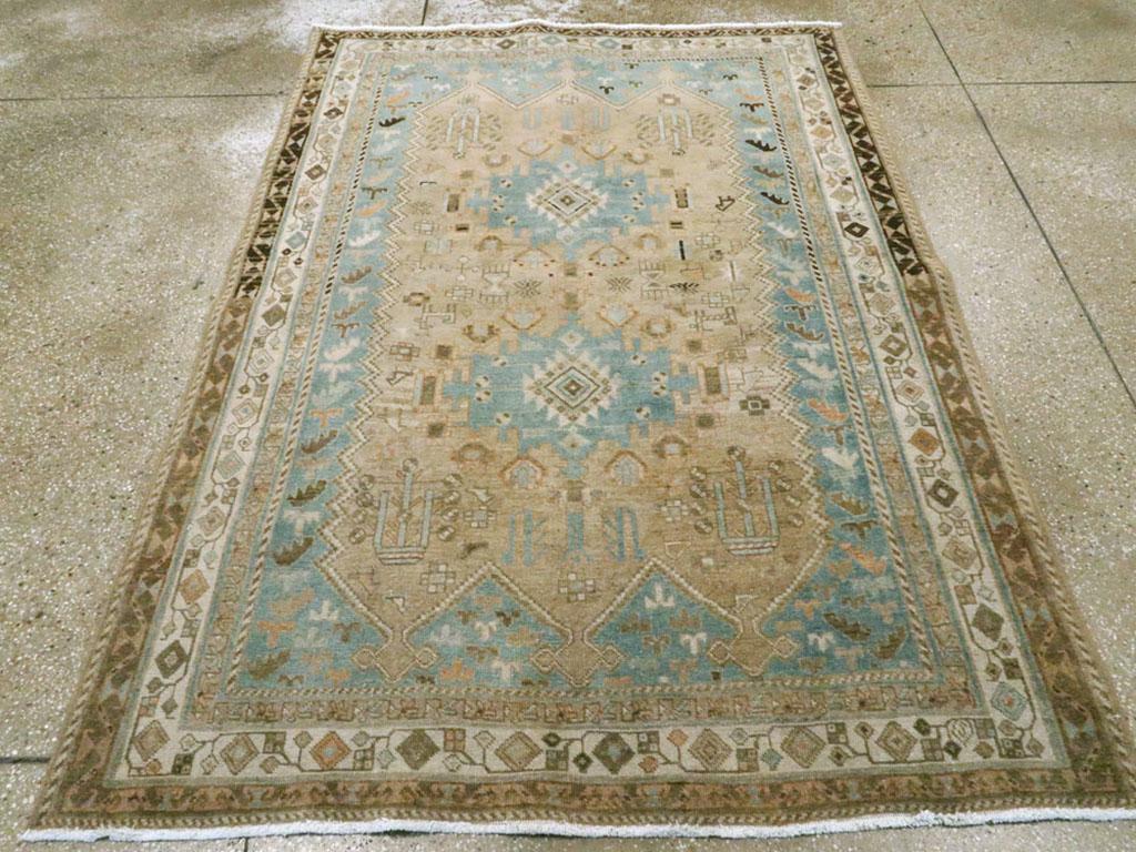 A vintage Persian Afshar accent rug. The light blue-grey field displays a sand panel with three points at each end, centering a pole medallion of two light blue square cartouches enclosing ivory ashiks. Leaves spill down along the field sides. The
