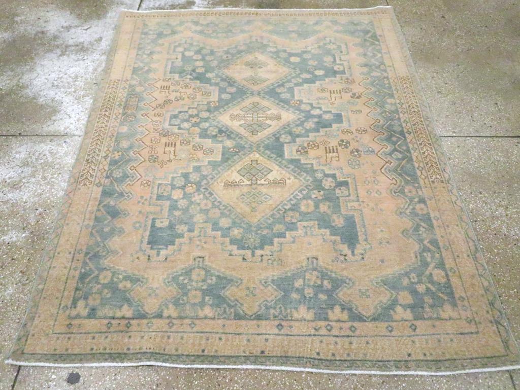 Our most popular SW Persian tribal rug design. The light slate cartouche medallion is strongly double pinched and stepped, with a three-panel central pole medallion of hooked diamonds with stylized palmette crosses. Three finial buff subfield with