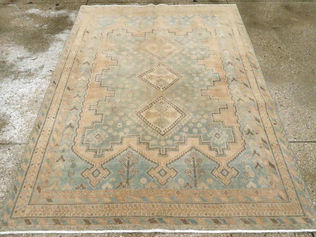The tribal Afshar weavers of SE Persia have narrow looms and therefore specialize in scatters such as this one with matching abrashed pale blue-grey field and rosette – filled cartouche panel centered by a pole medallion of three conjoint hooked