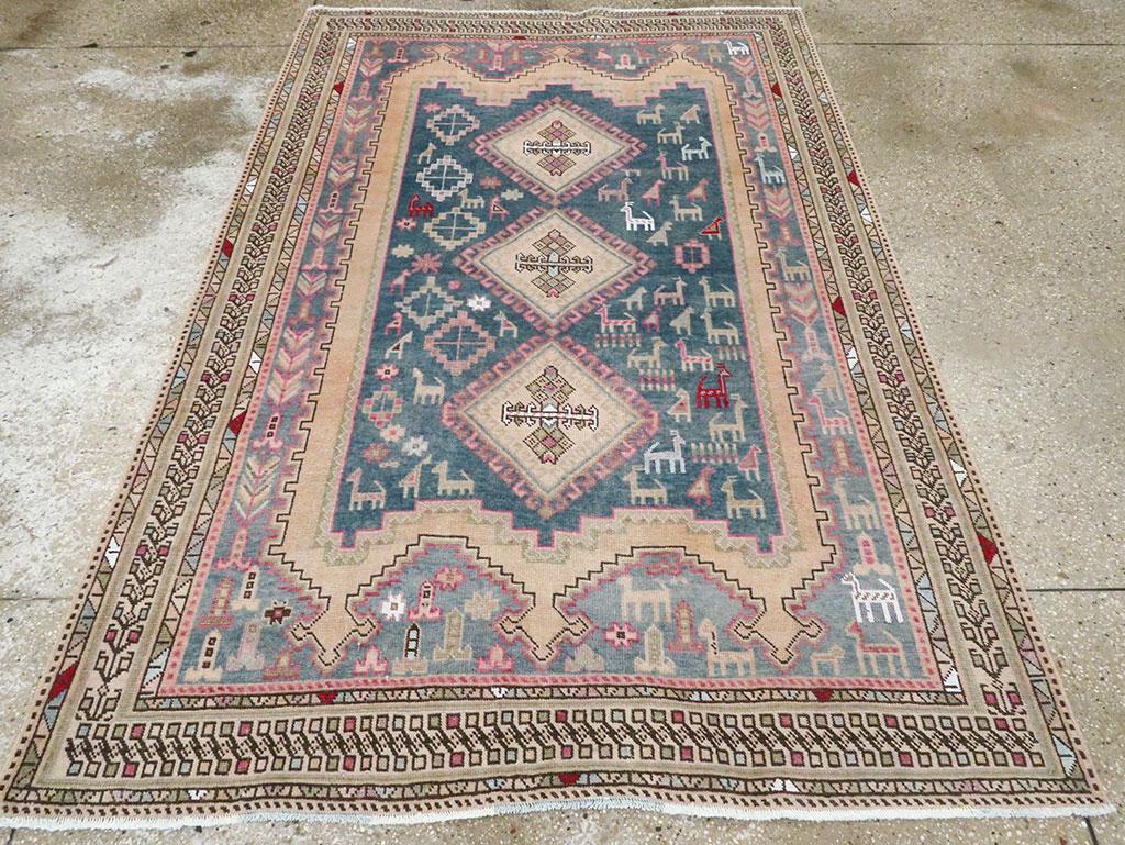 This large dozar (scatter rug) shows a dark slate smooth sided cartouche with numerous birds and animals (probably goats or sheep), on a straw-buff subfield, enclosed by a lighter slate field decorated with more birds and animals, Left and right