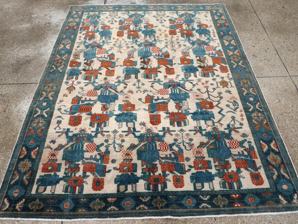 A vintage Persian Afshar accent rug. This attractive SE Persian tribal scatter displays four rows of extremely colorful abstract open floral bouquets in a Gol-i-Firangi (European flower) style in red, roe and royal blue on an old ivory ground.  The