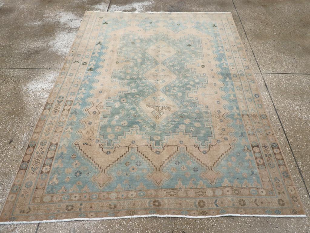 A vintage Persian Afshar accent rug. A pole medallion of three conjoint hooked straw diamonds centers the light blue-grey step-waisted sub—sub-field with a decoration of lazy S’s and rosettes. The inclusive straw subfield shows triple triangles at