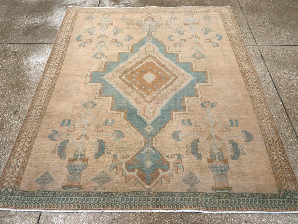 A vintage Persian Afshar accent rug. Roughly in the same style as rug # 27198, this SE Persian tribal scatter adds a central lozenge rust sub-medallion while omitting the sawtooth edges to the encompassing, stepped slate medallion. The corner