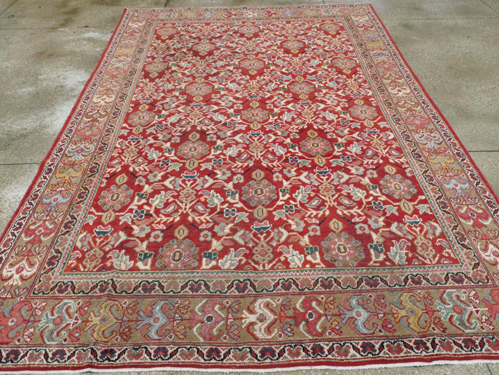 A vintage Persian Mahal carpet from the mid-20th century in accent size format. There are eight offset rows of colorful rosettes with double-leaf brackets on a brick-hued field. The light brown main border is patterned with floral chains including