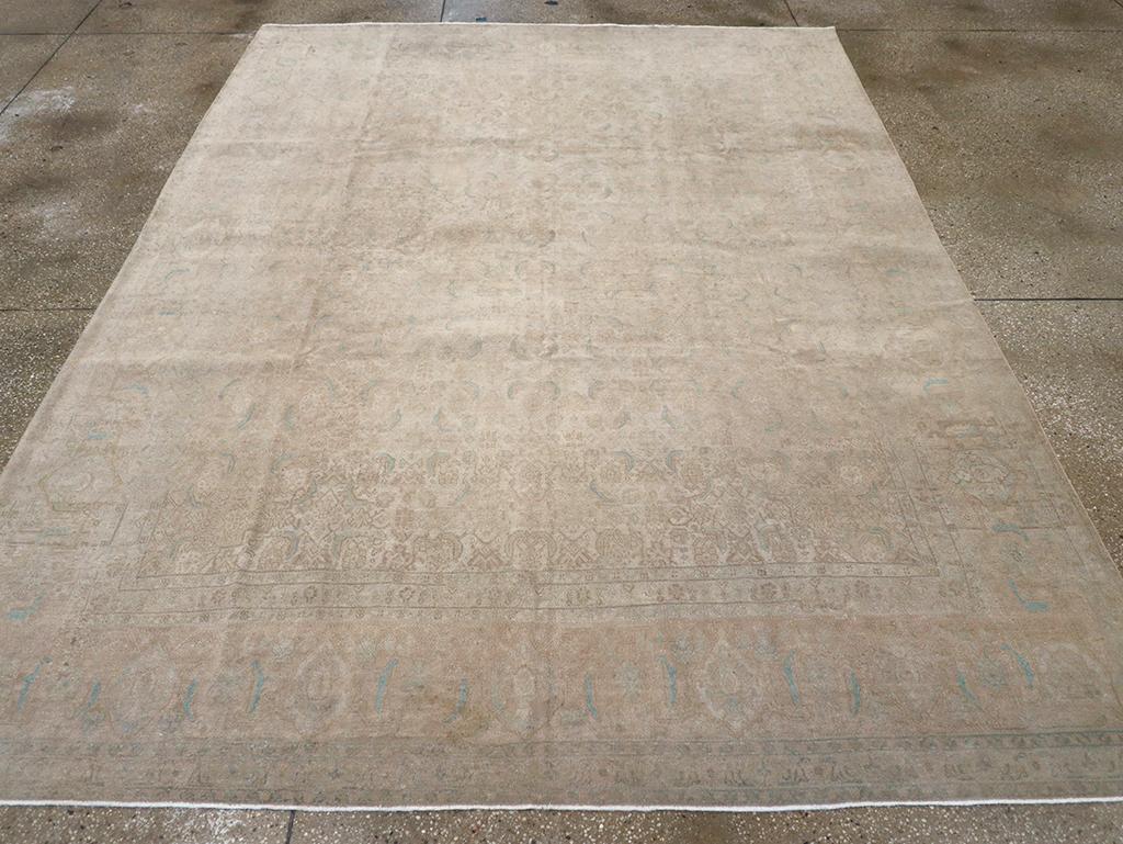 A wool pile of asymmetric knots on a cotton foundation. The lightly drawn and accented allover Herati-inspired pattern is nearly subsumed into the sandy field. The equally subdued border features reversing turtle palmettes in a modified strip