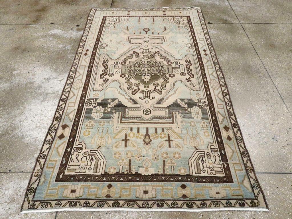 Un tappeto d'accento persiano vintage Malayer. Questo spargimento, generalmente di colore chiaro, mostra un medaglione di sabbia alato con dettagli in marrone scuro, tra cui piccole rosette, su un fritto decisamente abraso che va dal carbone al