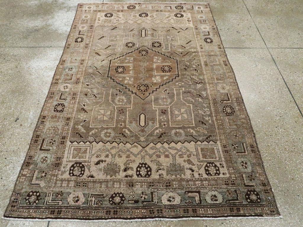 A vintage Persian Malayer accent rug. Old ivory field sections cross at each end with dark brown rosette, ‘fish’ leaves and a few tiny birds, and frame the taupe subfield with a terra-cotta stepped, hexagon central medallion. Rosettes and