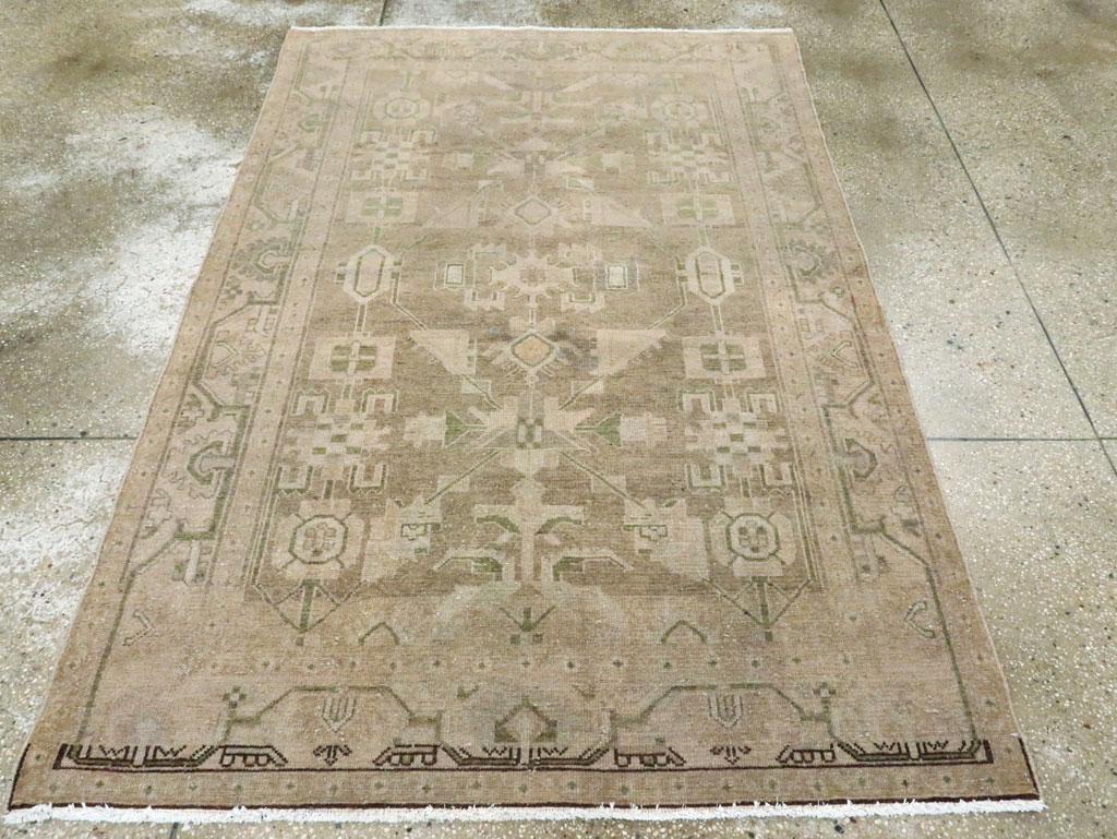 This is an example of our most popular Malayer type, here with a rust field showing triangles, squares, hexagons, oblique rhomboids, and color sampler rosettes. Beige border with lobed, triangular palmettes on a trapezoidal meander. West Persian,