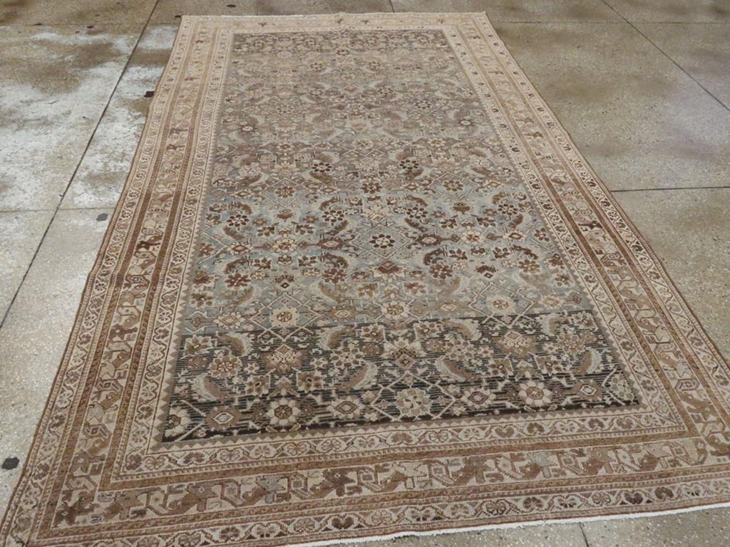 A vintage Persian Malayer accent rug. The ever-popular Herati leaf and rosette pattern appears here on an abrashed taupe to the dark brown field. The ivory main border employs the “dragon” vine pattern seen on many west Persian scatters and