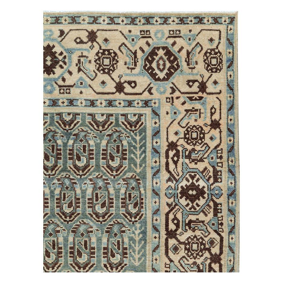 A vintage Persian Malayer accent rug handmade during the mid-20th century with a geometric paisley design and turtle palmette border over shades of green, cream, and blue-grey.

Measures: 4' 8