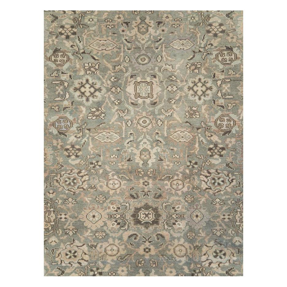 A vintage Persian Malayer room size carpet handmade during the mid-20th century with an all-over design over a slate-green field and an acanthus scroll leaf design over a purple-grey border.

Measures: 8' 6