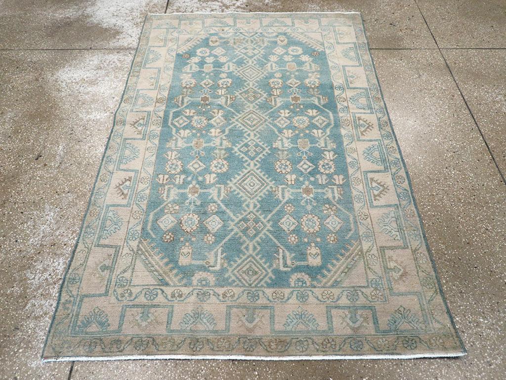 A wool pile of symmetric knots on a cotton foundation. The medium slate-blue ground displays a distinct Malayer version of the Herati design, with a central column of attached diamonds flanked by tiny botehs, squat leaves, small diamonds, and