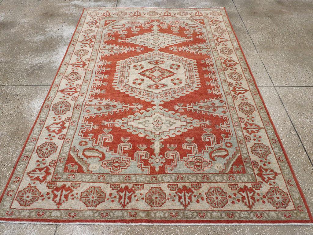 A wool pile of symmetric knots on a cotton foundation. While the layout is common to both small rugs and large carpets, nothing here remotely resembles a traditional Viss. The cardinal red field features a central axis anchored by a densely hooked,