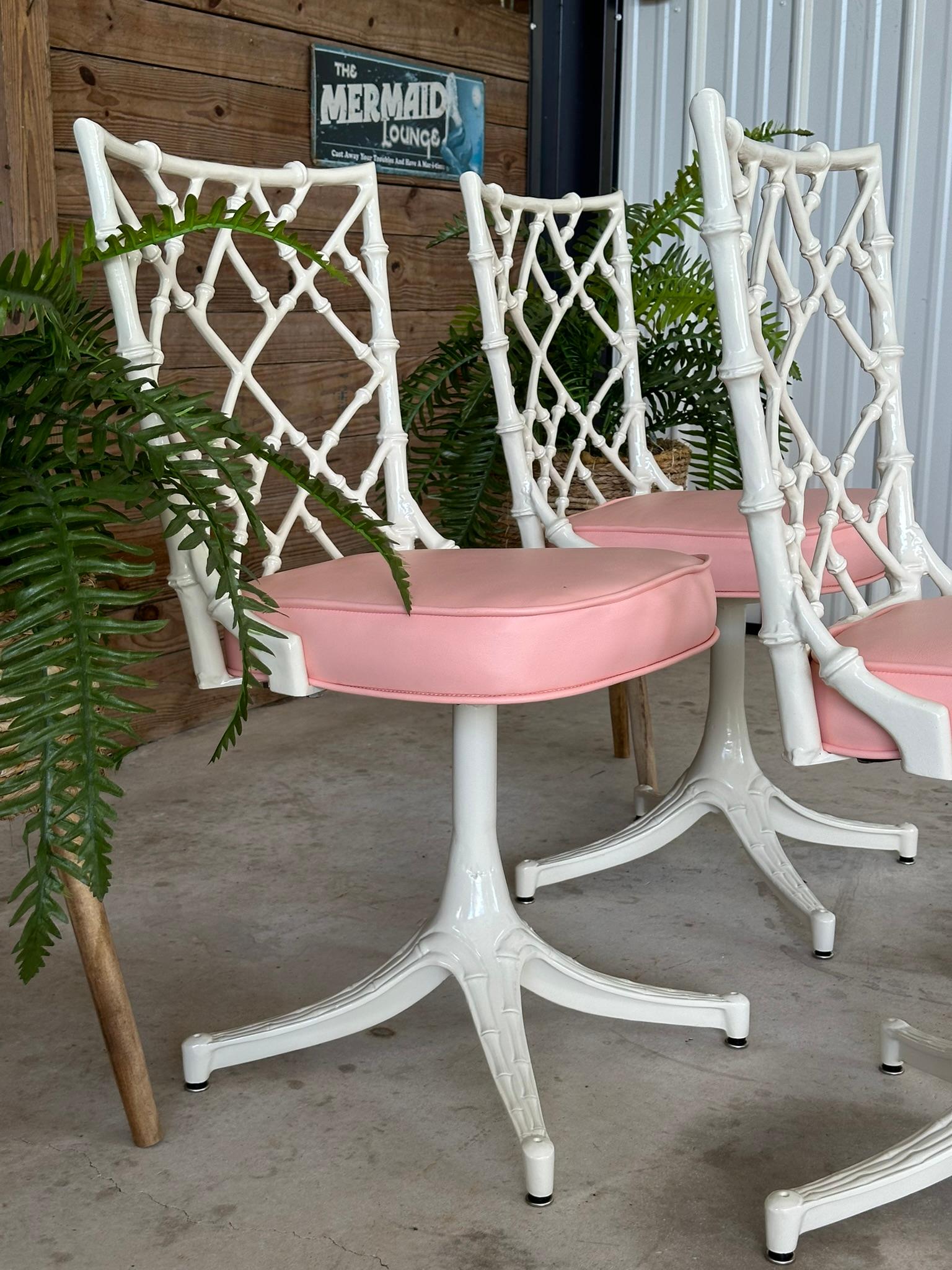 Introducing an exquisite set of four faux bamboo aluminum outdoor chairs, featuring a durable powder-coated finish in Oyster and brand-new Blush pink vinyl upholstery. This Coastal Regency set is perfect for enhancing your outdoor space or as a chic
