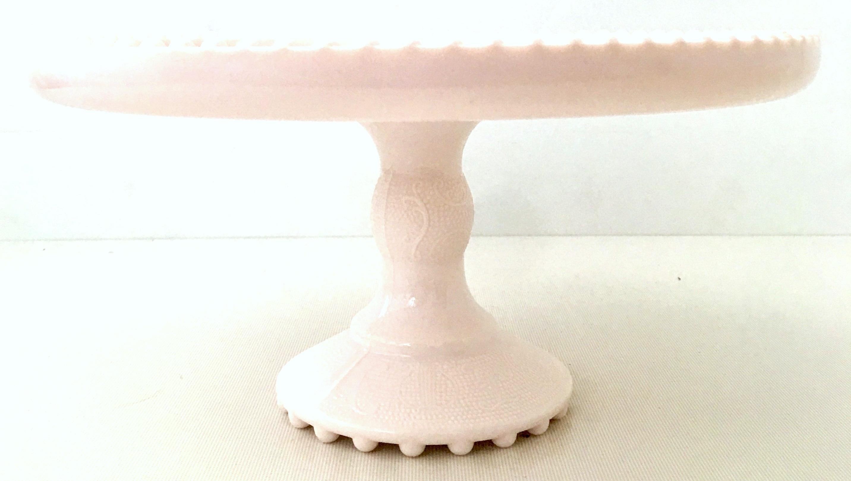 Mid-20th century pink milk glass pedestal cake stand.