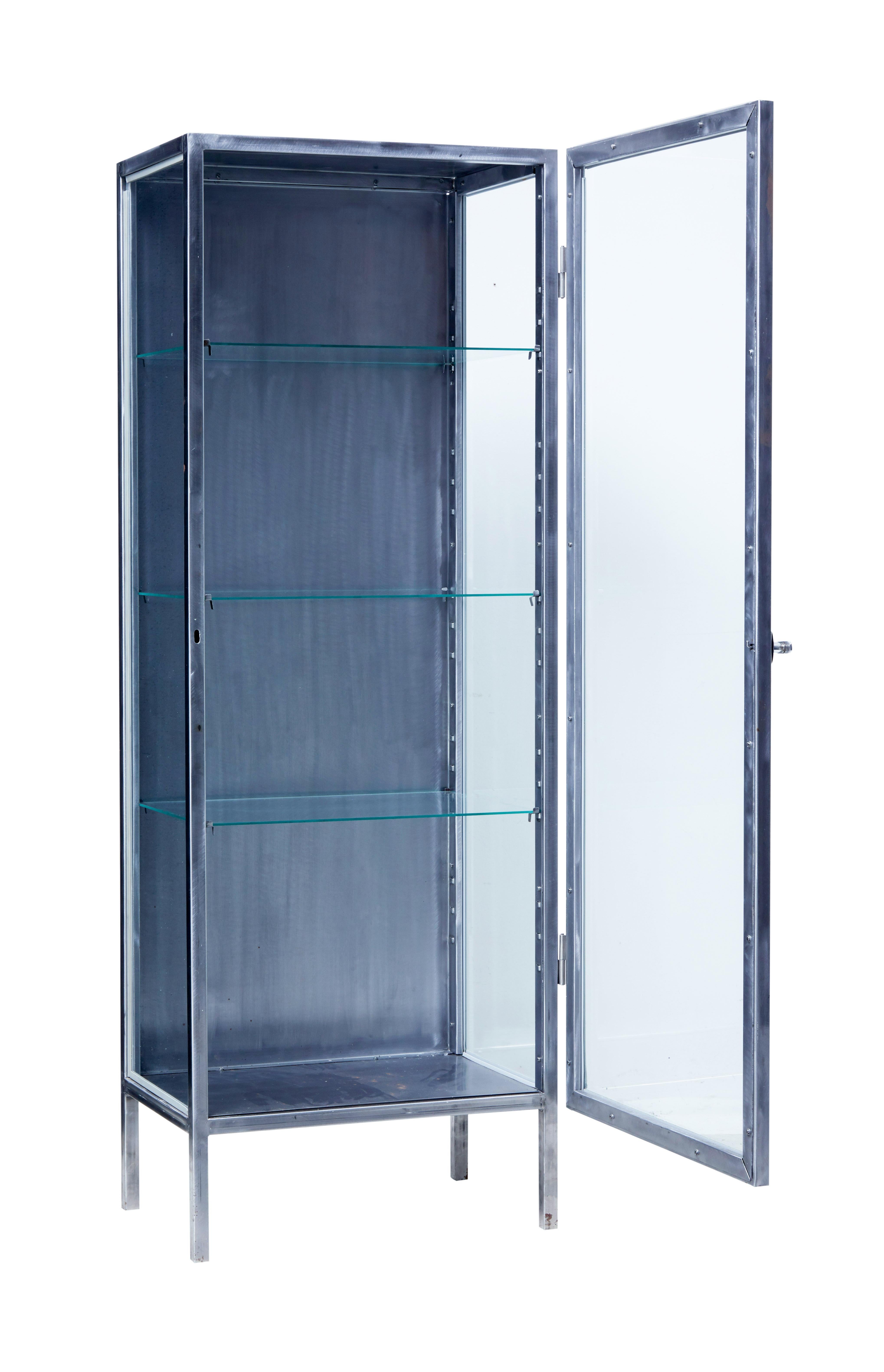 Good quality 1940s Scandinavian steel medical cabinet.

Tubular frame, with a single door to the front which allows access to 3 glass shelves.

Ideal for a retail display or for use in the home.

Minor loss to 1 glass shelf on the back edge,