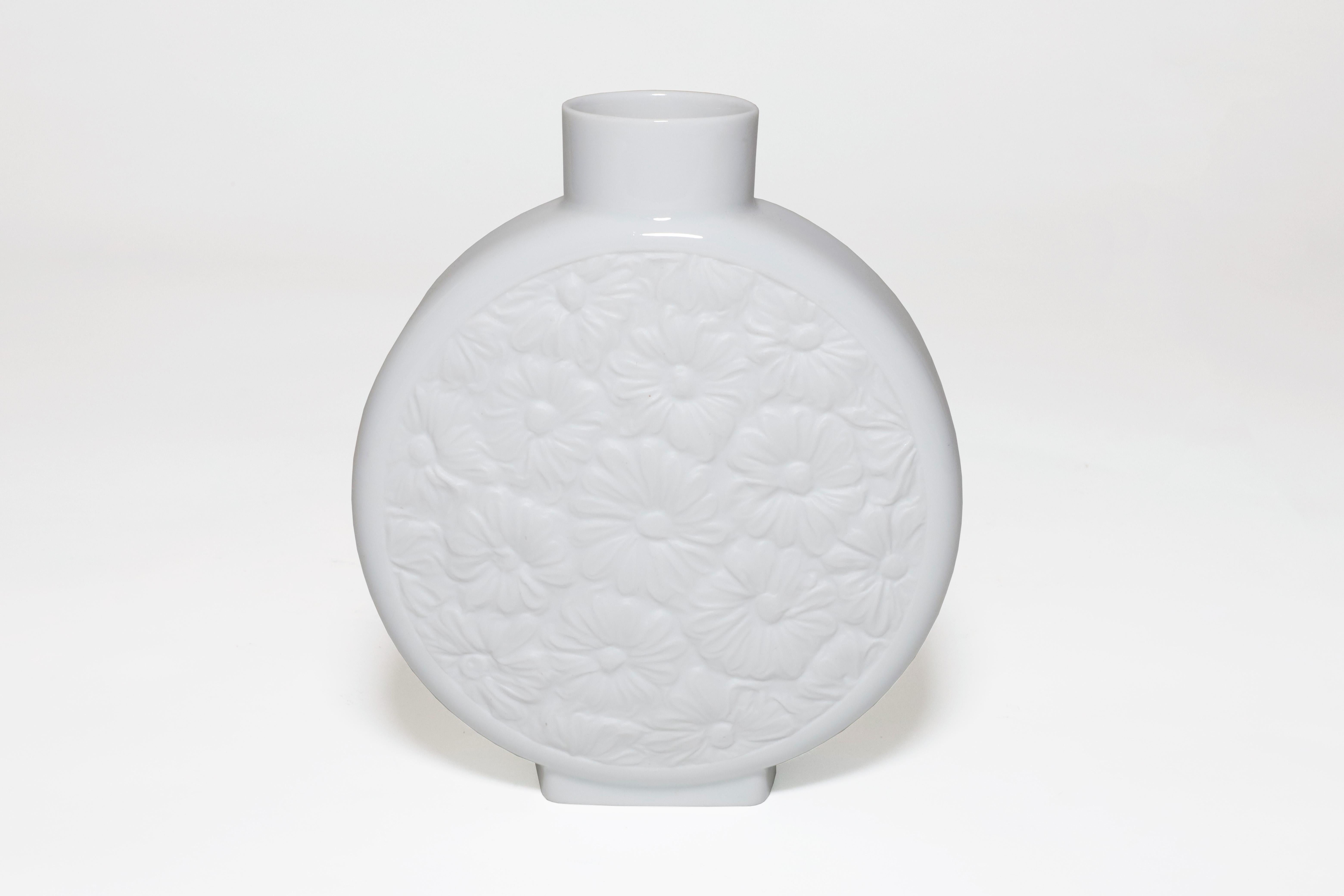 Slender white porcelain vase by Krautheim Selb Barvaria. Mate flower design on each face with a glossy white glaze around the rest of the vase. Stamped on the bottom. Made in Germany in the mid 20th century. 

Property from esteemed interior