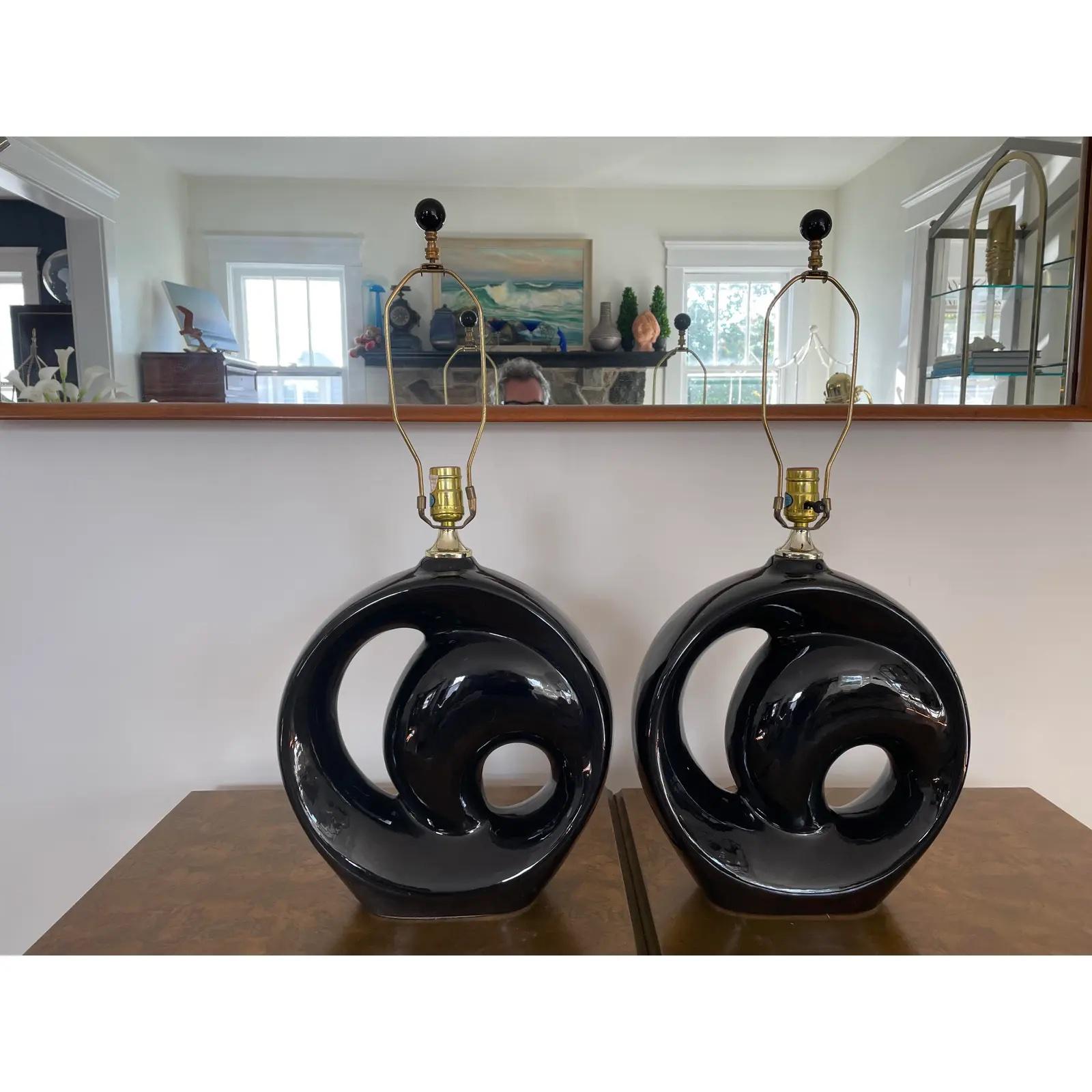 Awesome pair of post modern glazed ceramic lamps in the style of Royal Haeger. Black circular design invoking a nautilus feel. Shades are for staging and not included.