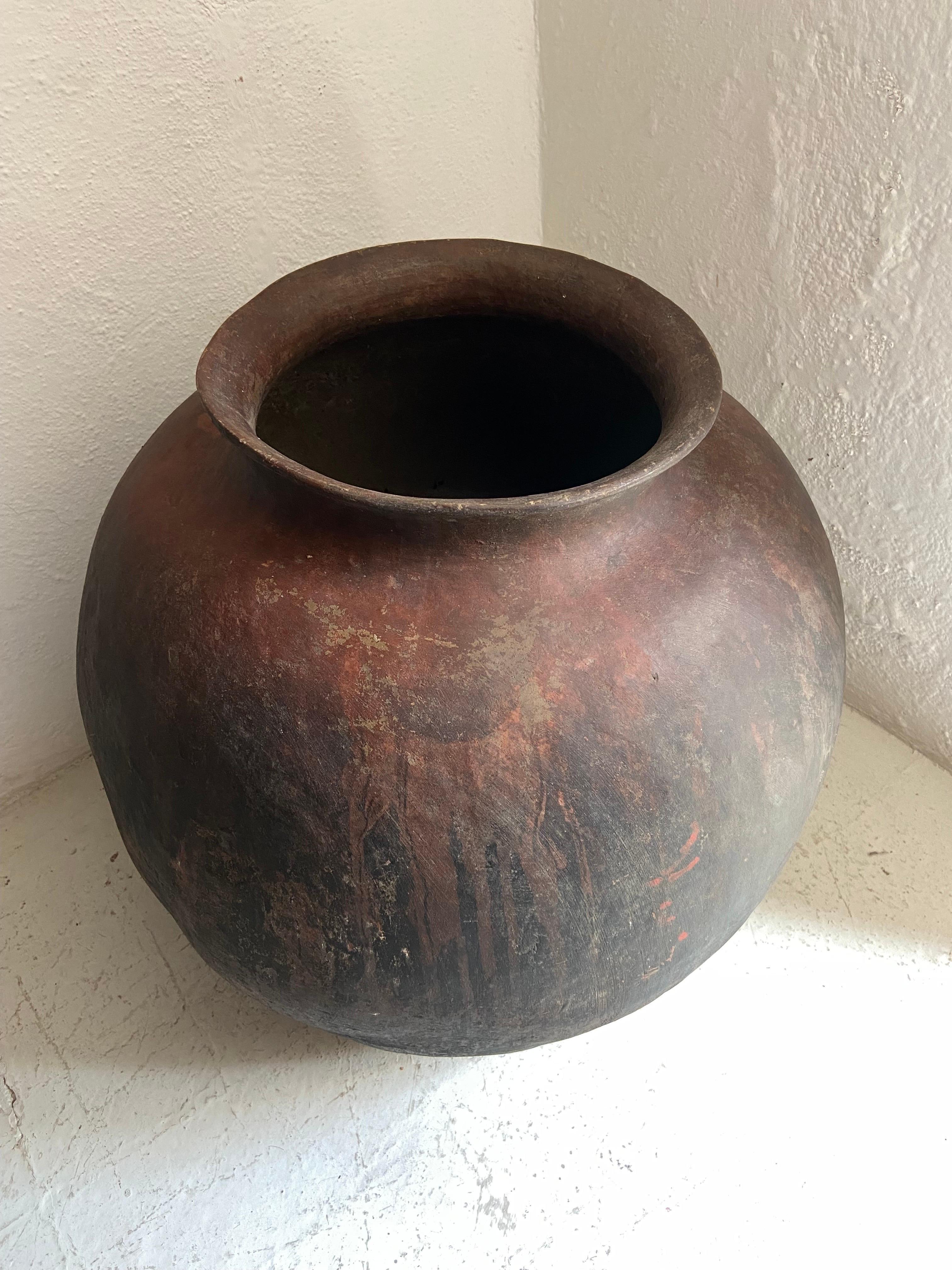 Mid-20th Century pot from the remote sierras of Michoacan, Mexico. These large vessels were used to store water for household use. The rounded shape of this pot is unusual as is the weight.