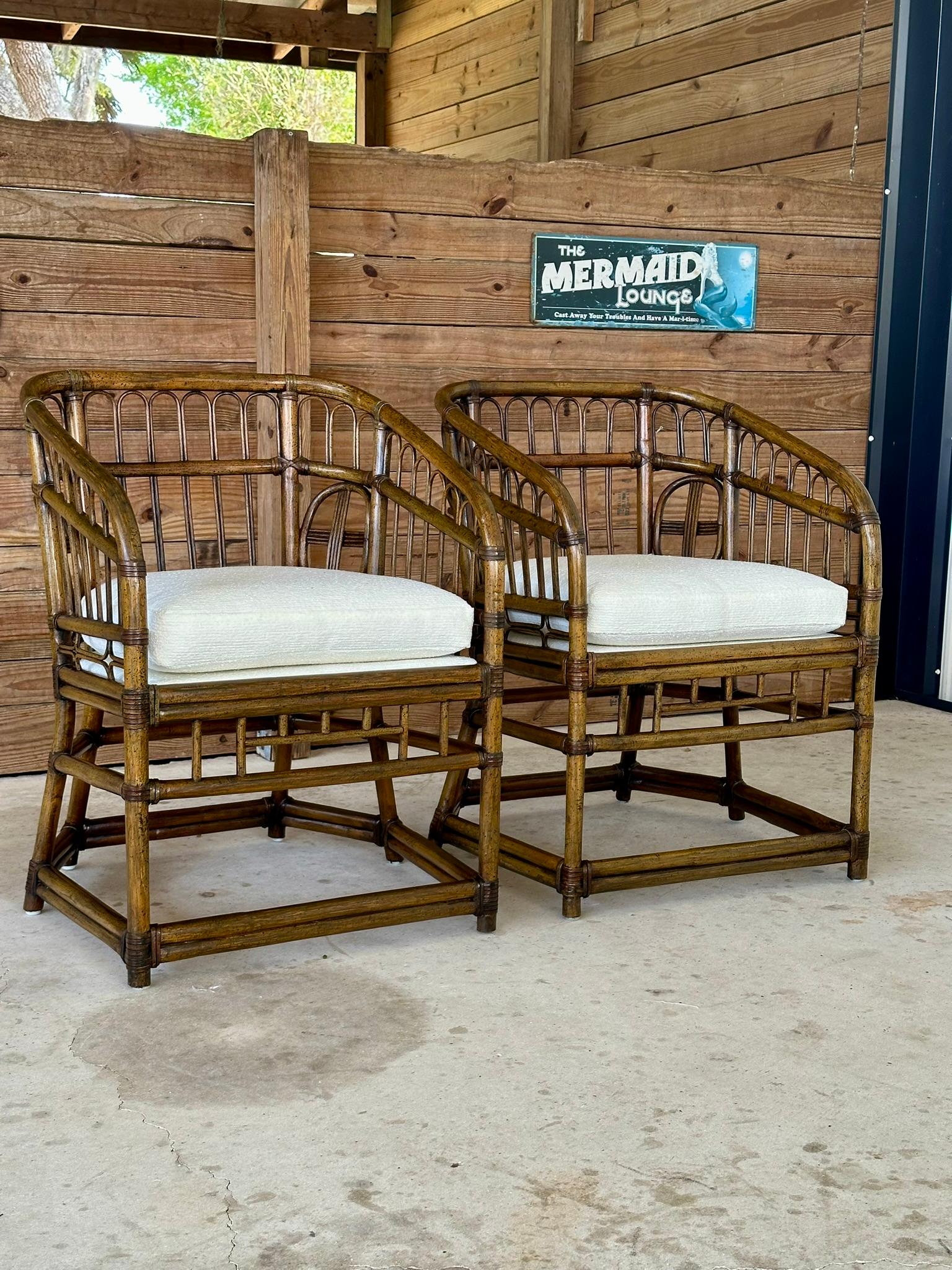 Introducing an exquisite pair of vintage mid-20th century rattan tub side chairs by Lewittes, beautifully refinished to bring out their intricate rattan craftsmanship. Each chair is elegantly upholstered in new, textured off-white Sunbrella fabric,