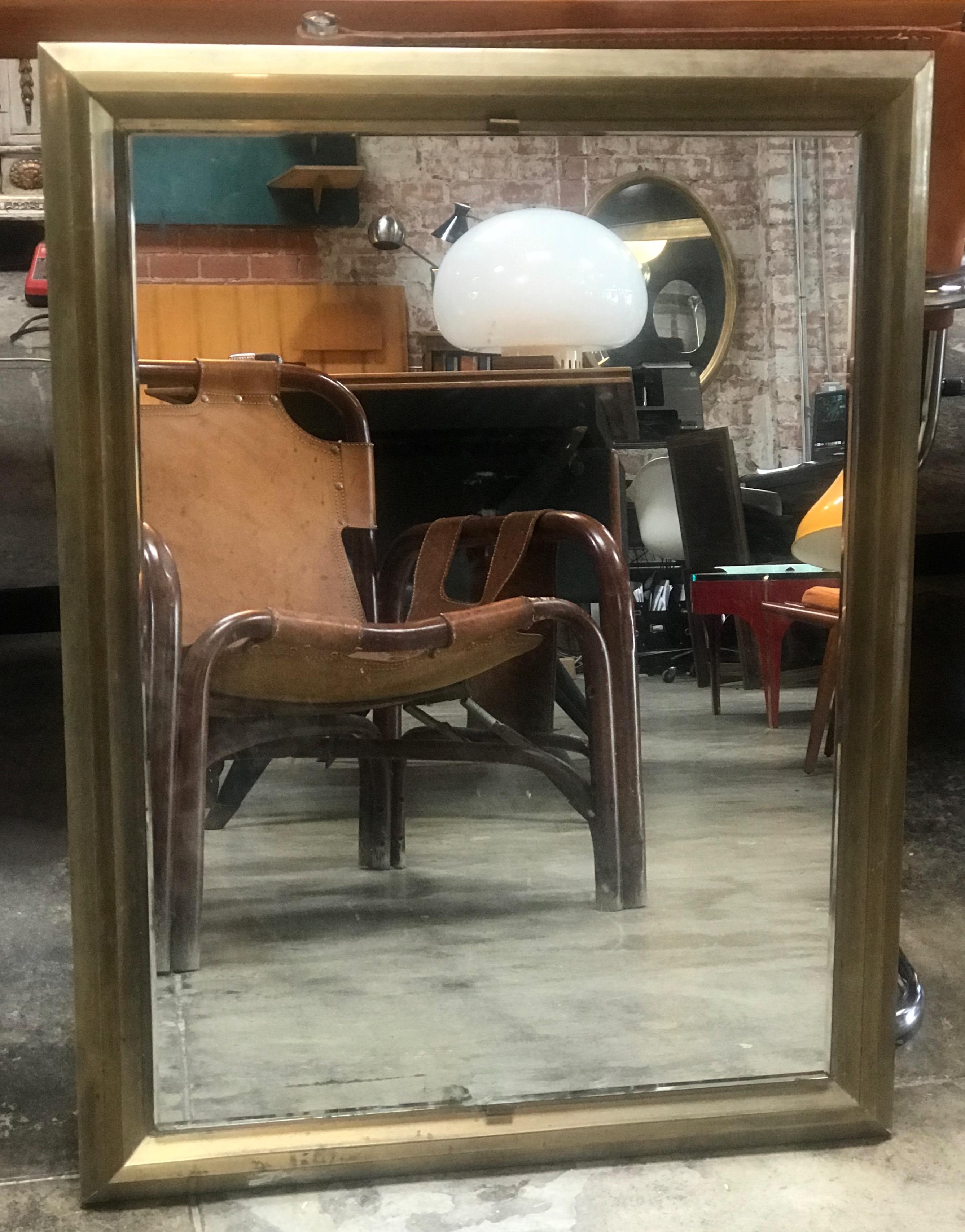 Mid-20th century Rectangular mirror with brass surround, Italy, 1950s
This simple and elegant vintage Italian mirror features a rectangular shape with brass surround, which has a lovely patina throughout. This is a good sized mirror: the clean