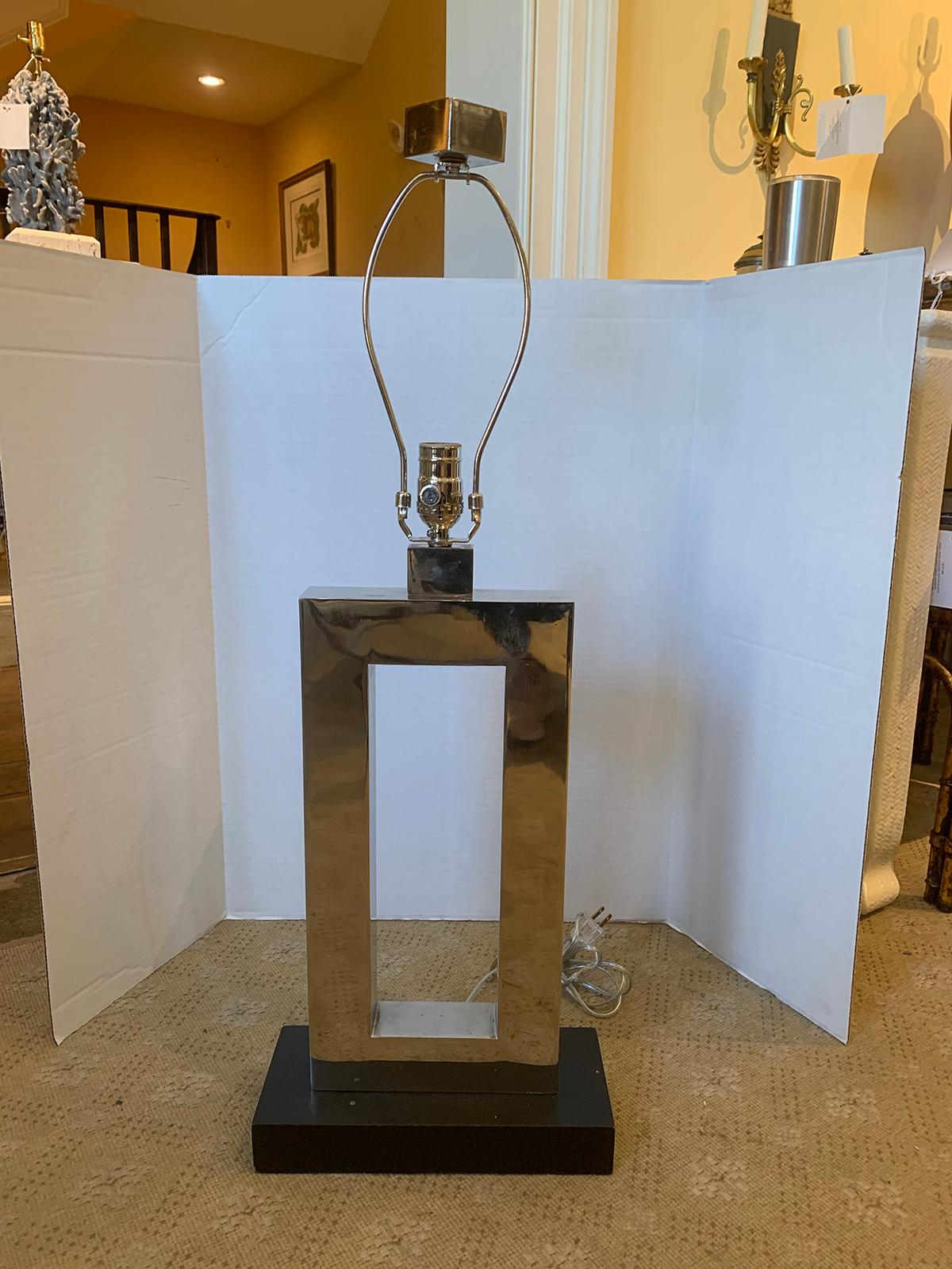 Mid-20th century rectangular silver lamp with matching finial. Black wood base
New wiring
Height is measured to the top of the socket.