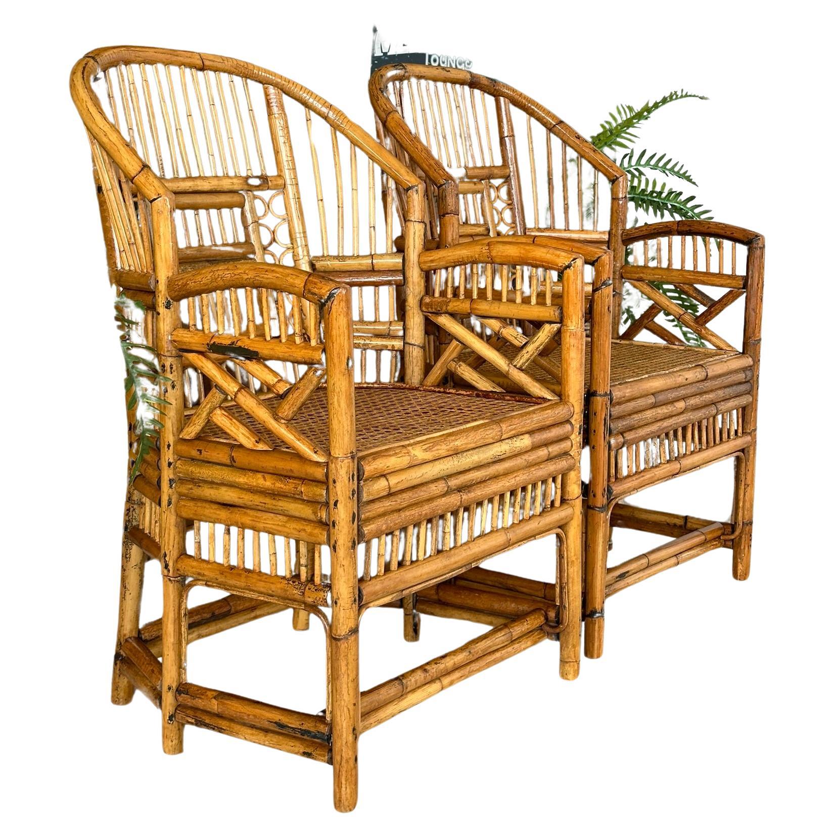 Add a touch of tropical Coastal elegance to your space with these exquisite vintage refinished rattan side arm chairs. Crafted with sturdy rattan frames, these chairs feature intricately woven cane seats, bent rattan details for offering both