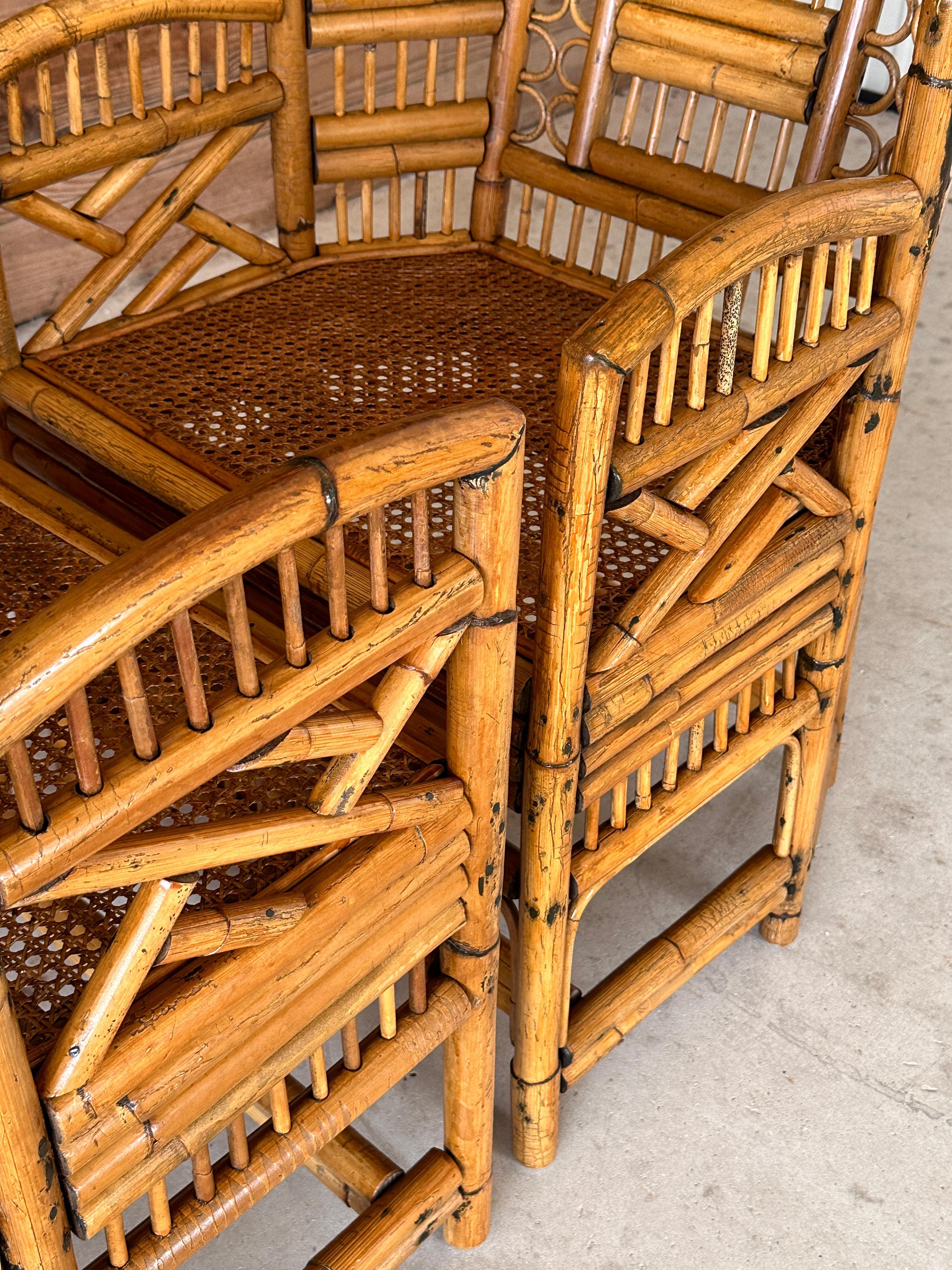 Add a touch of tropical Coastal elegance to your space with these exquisite vintage refinished rattan side arm chairs. Crafted with sturdy rattan frames, these chairs feature intricately woven cane seats, bent rattan details for offering both