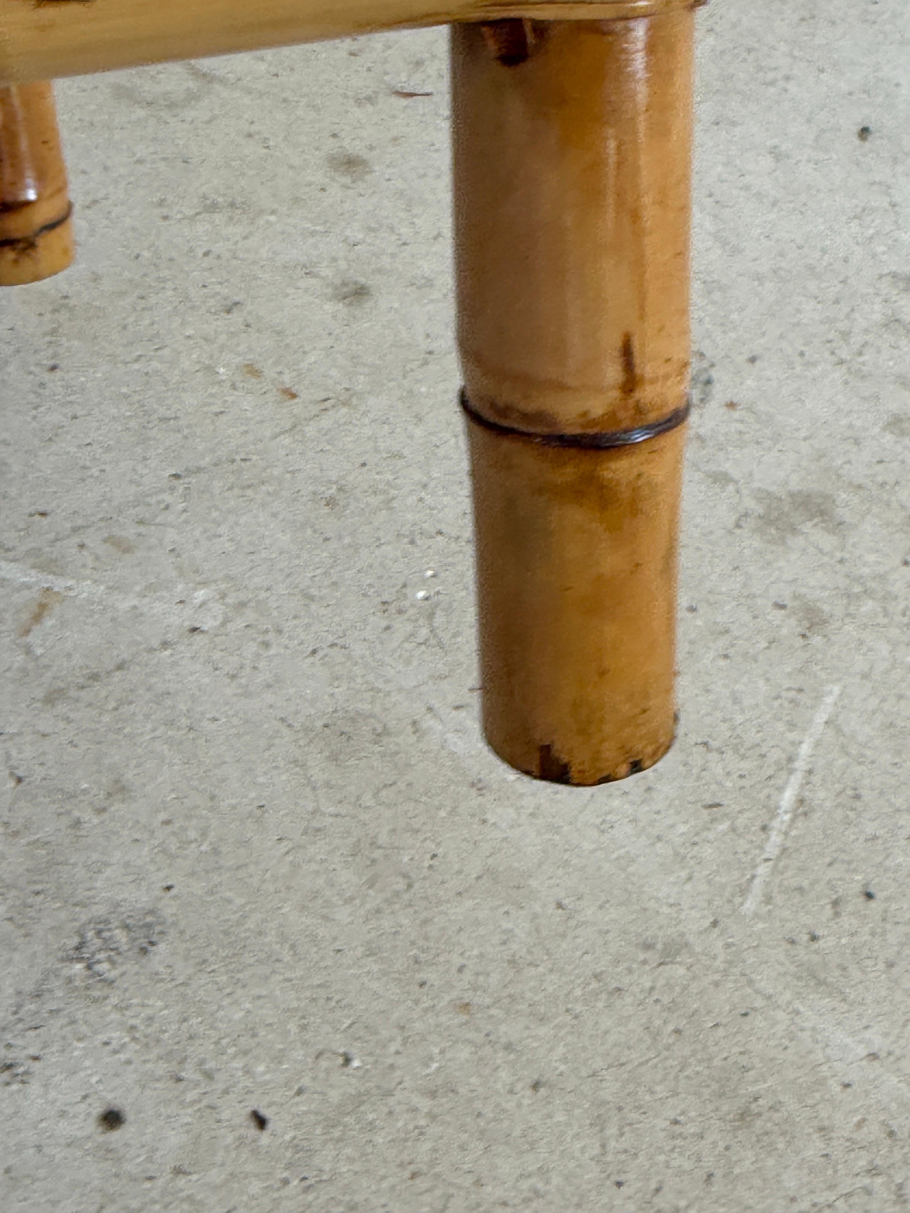 Charming Mid-20th Century demi-lune table crafted from burnt bamboo and fully refinished to bring out its warm golden tones. The arched bamboo details along the apron and the angular demi-lune design give it both structure and coastal elegance. A