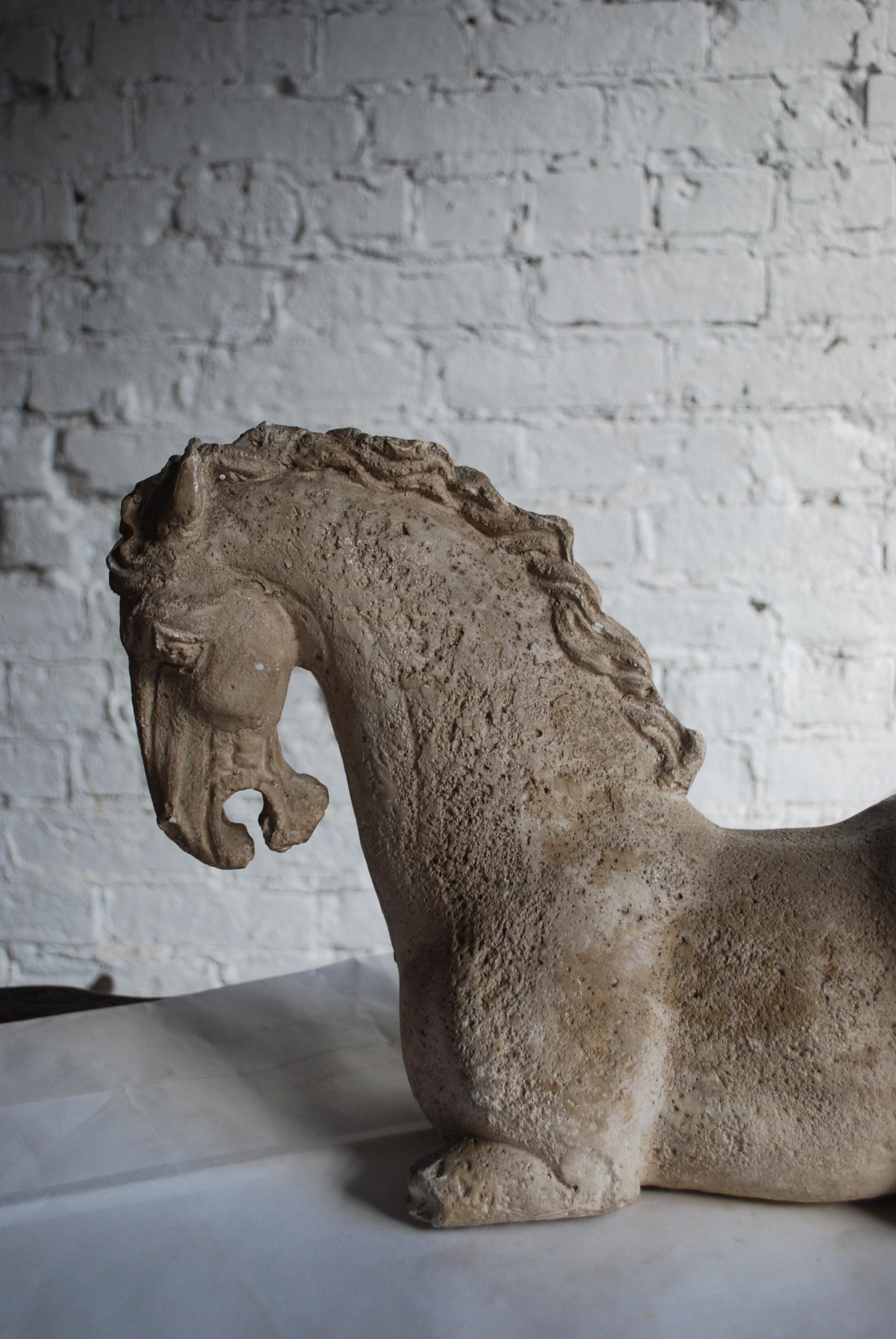 Mid-20th century reproduction of 17th century resting horse in plaster over iron.