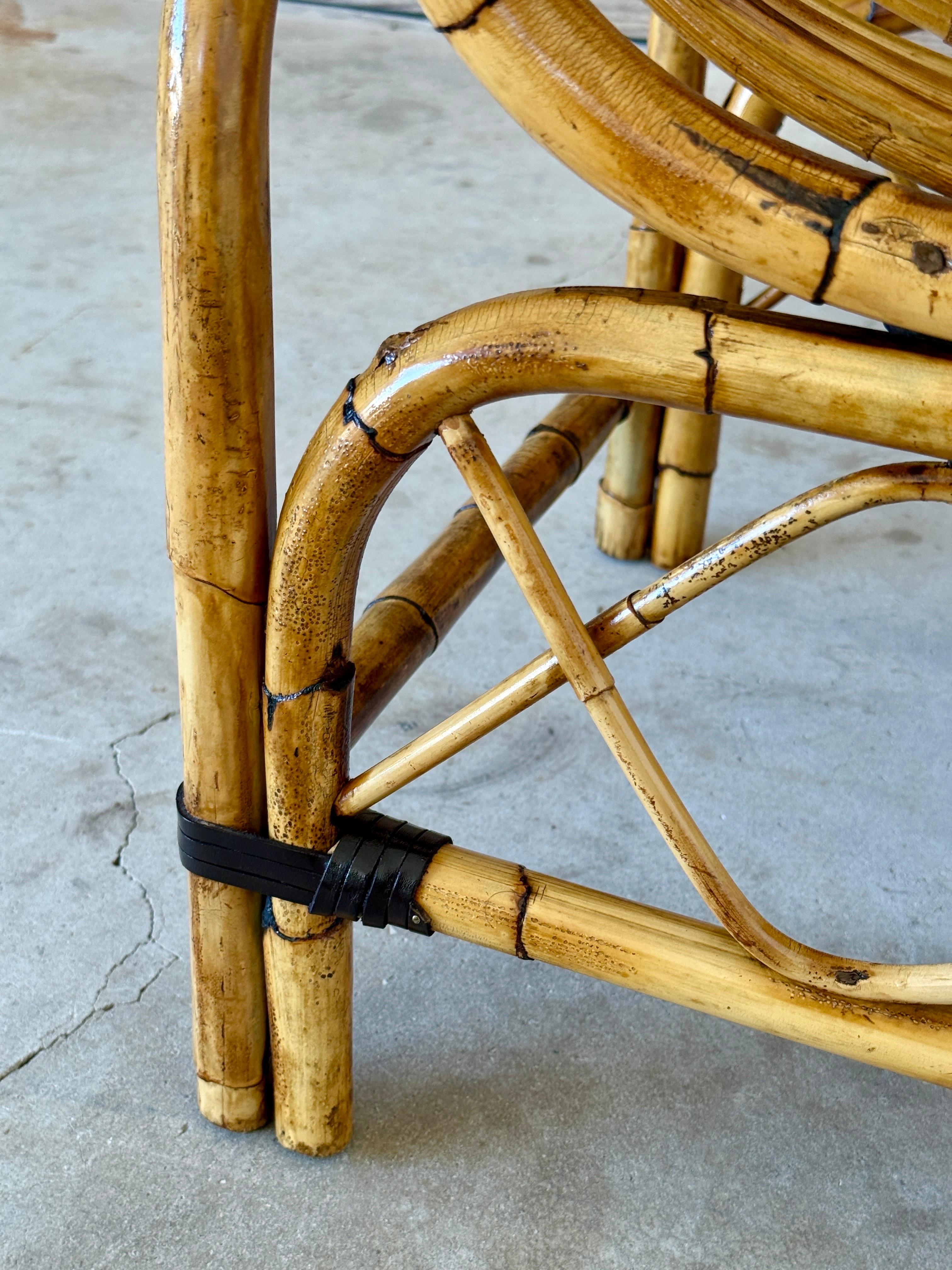 Charming mid-century bent rattan telephone seat or bench, restored to highlight its warm patina while preserving its vintage character. Features original smoked glass inset side table with some light scuffs, and the original green velvet cushion
