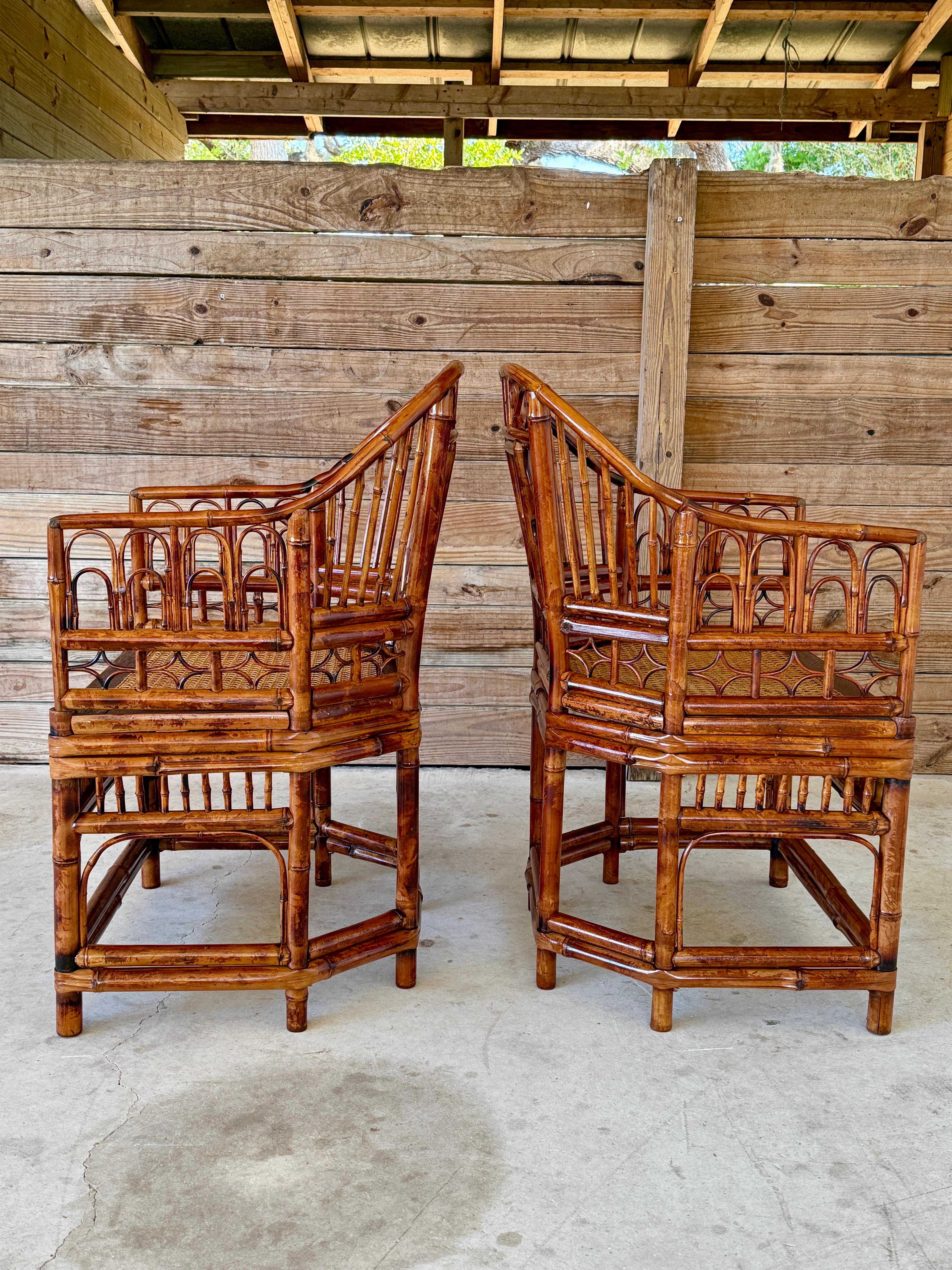 This exquisite pair of Brighton Pavilion-style armchairs showcases intricate bamboo fretwork, gracefully curved arms, and a warm tortoise finish.
The caned seats add texture and craftsmanship, making these chairs a perfect blend of elegance and