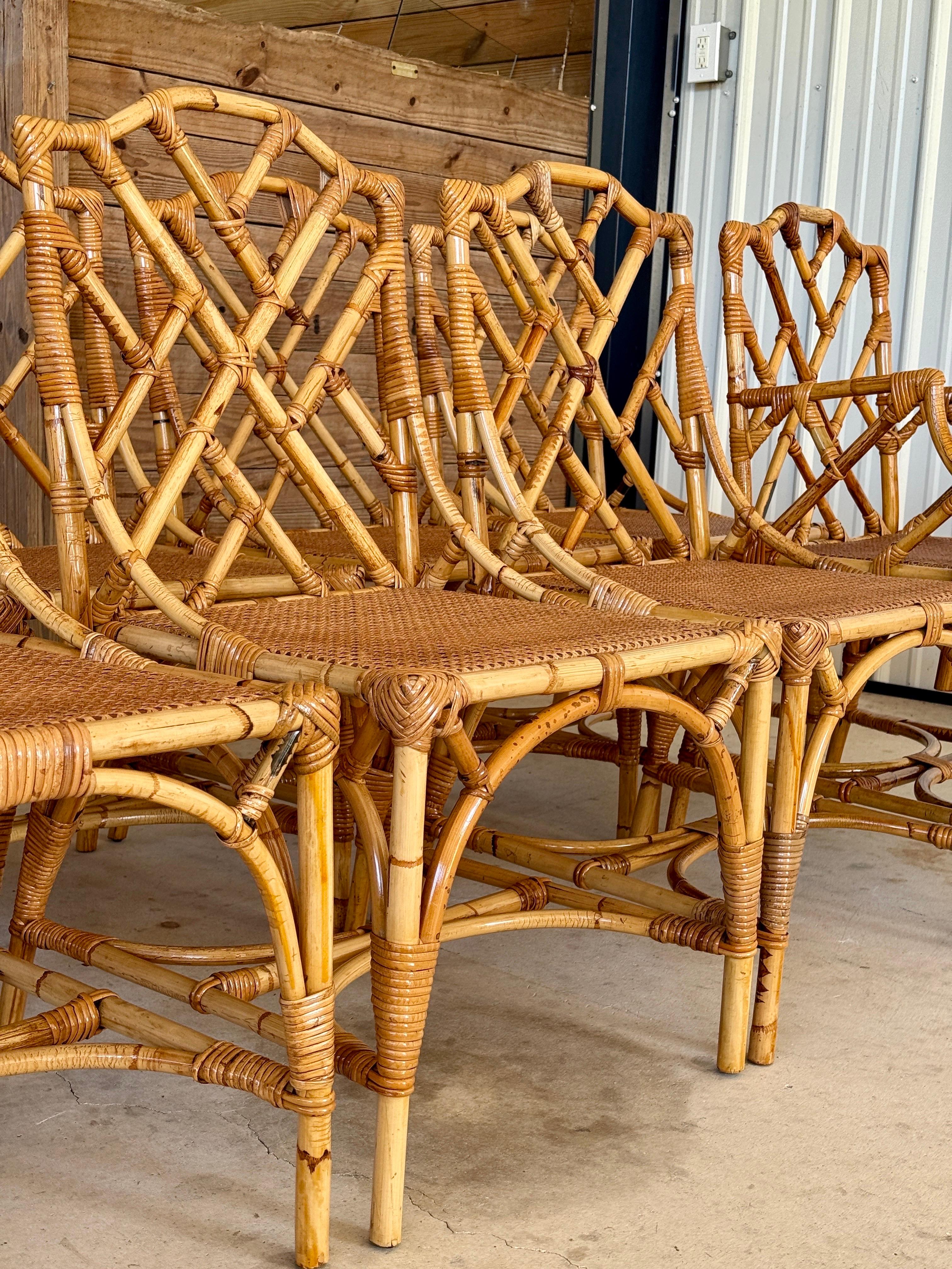 A stunning set of eight Mid-20th Century Dal Vera Italian rattan dining chairs, beautifully restored and refinished. Crafted in the classic Chippendale style, each chair showcases intricate fretwork backs and newly woven cane seats. These were