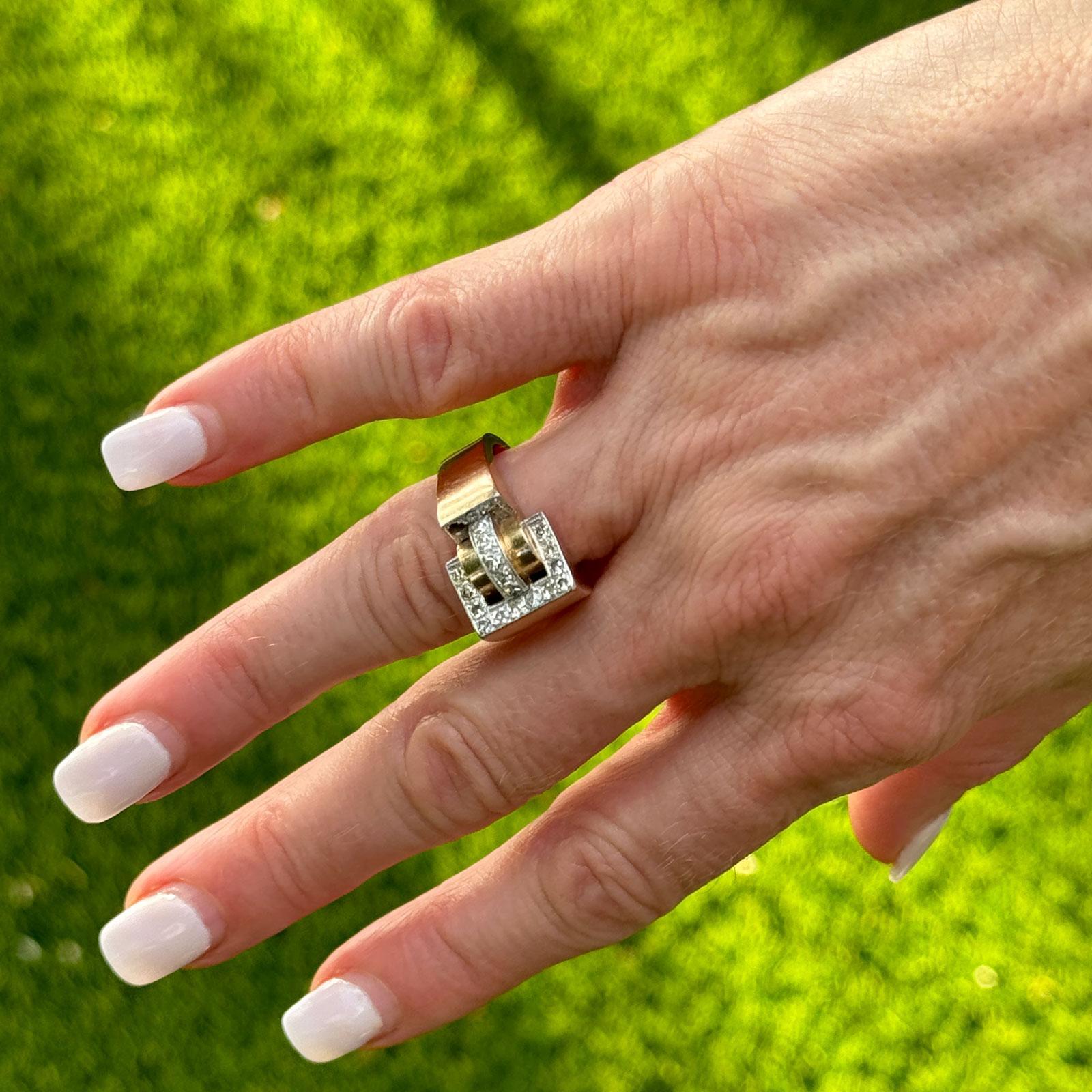 The Mid-20th Century Retro Diamond 18 Karat Rose Gold Vintage Ring is a captivating piece that embodies the bold and distinctive style of the era. Crafted in warm 18-karat rose gold, this ring features a striking retro buckle design highlighted by