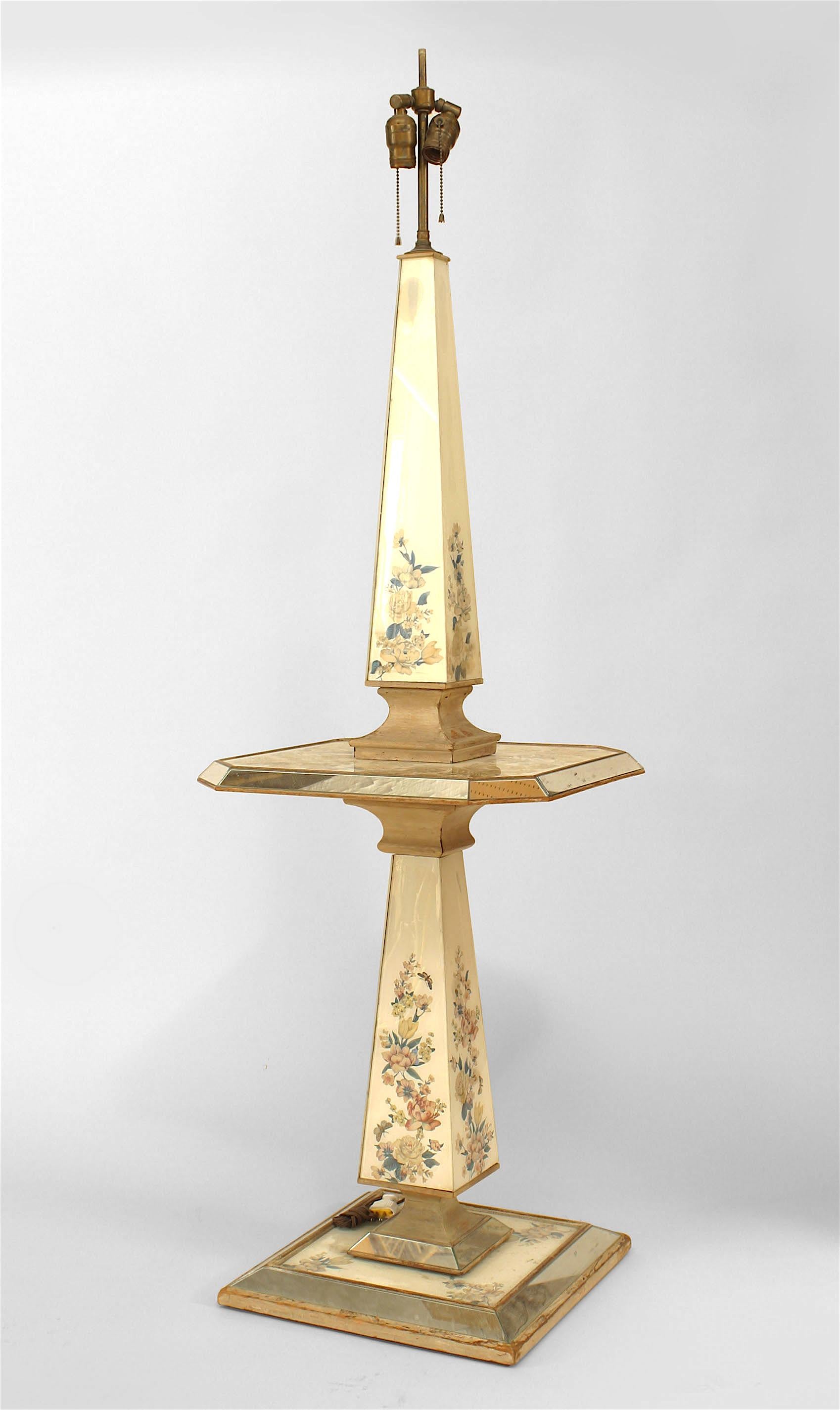 French 1940/50s two-tier floor lamp with mirrored and reverse painted obelisk columns on wood foot culminating in mirrored & reverse painted tiers with floral motif.
