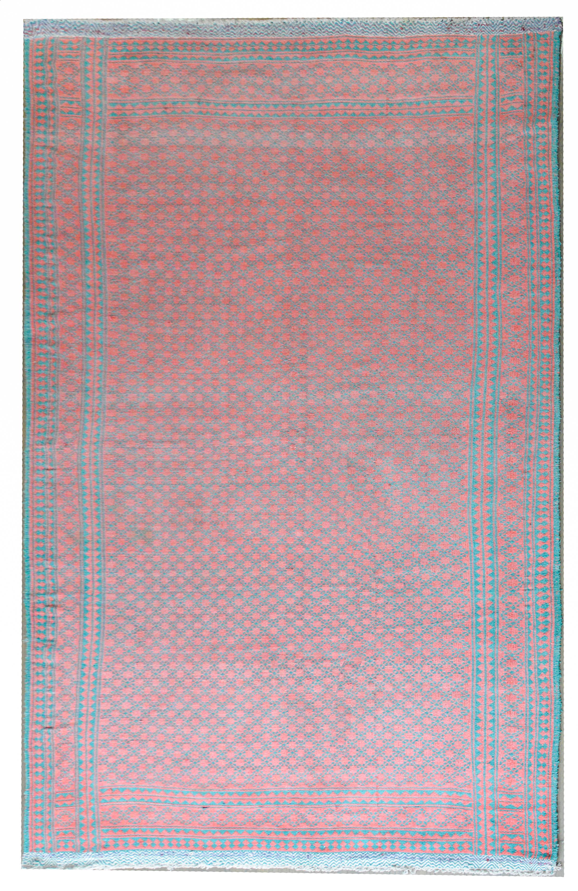 A fantastic mid-20th century Persian reversible Kilim rug with an all-over trellis start pattern in coral against a turquoise ground on one side, and the reverse with turquoise stars against a coral background on the other.