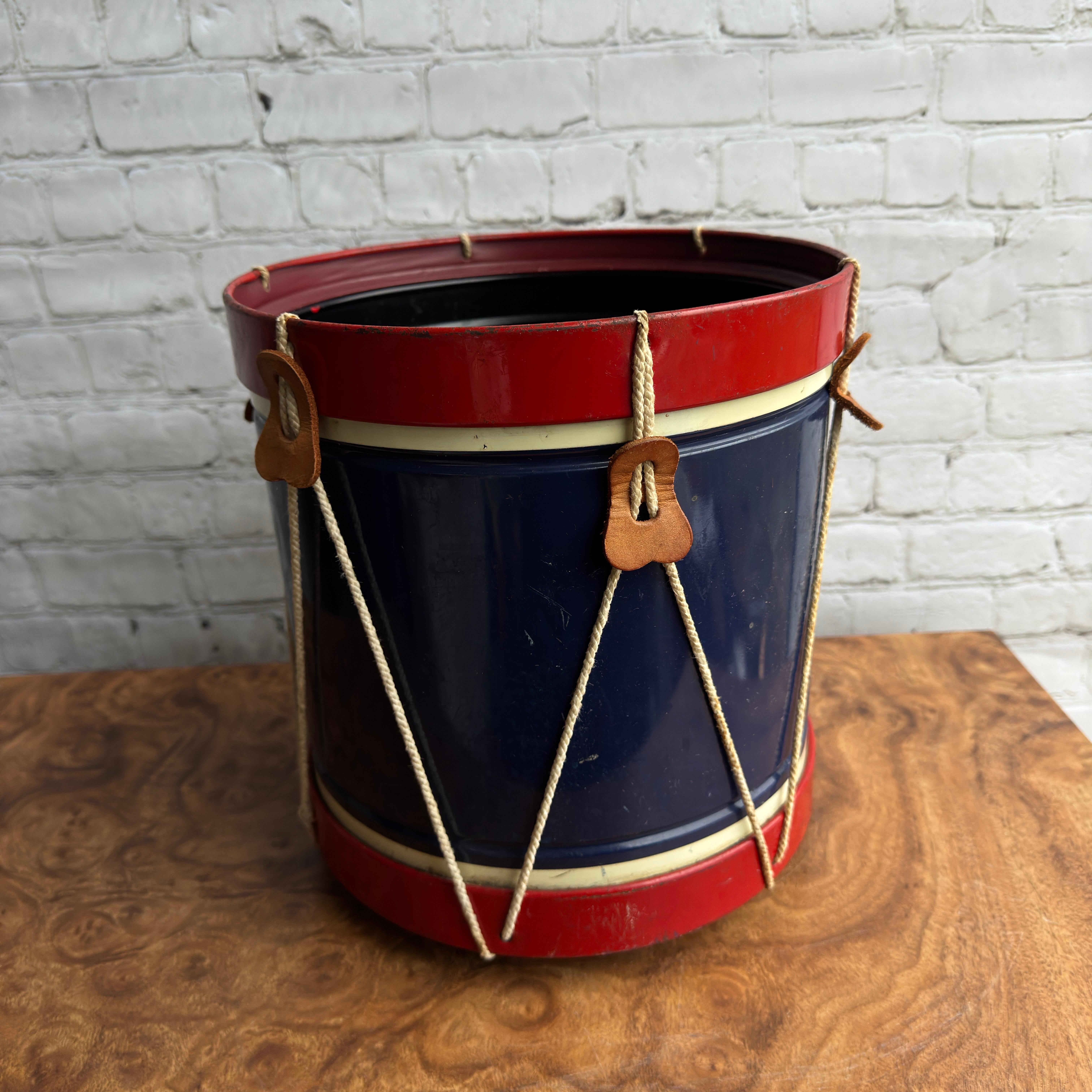 This darling wastebasket was likely produced around 1976, the big bicentennial of the founding of the United States of America. It’s composed of metal, plastic, leather, and rope. The majority of it is composed of metal. It is in decent shape for