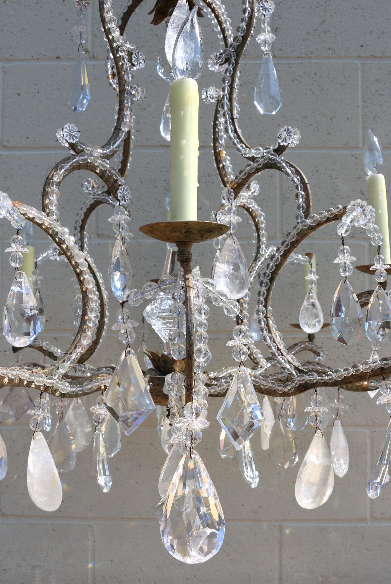 Wonderful eight light chandelier made of crystal and some rock crystals. It has a wonderful shape metal frame.  It is all completed. It has no missing parts. The condition is really good.