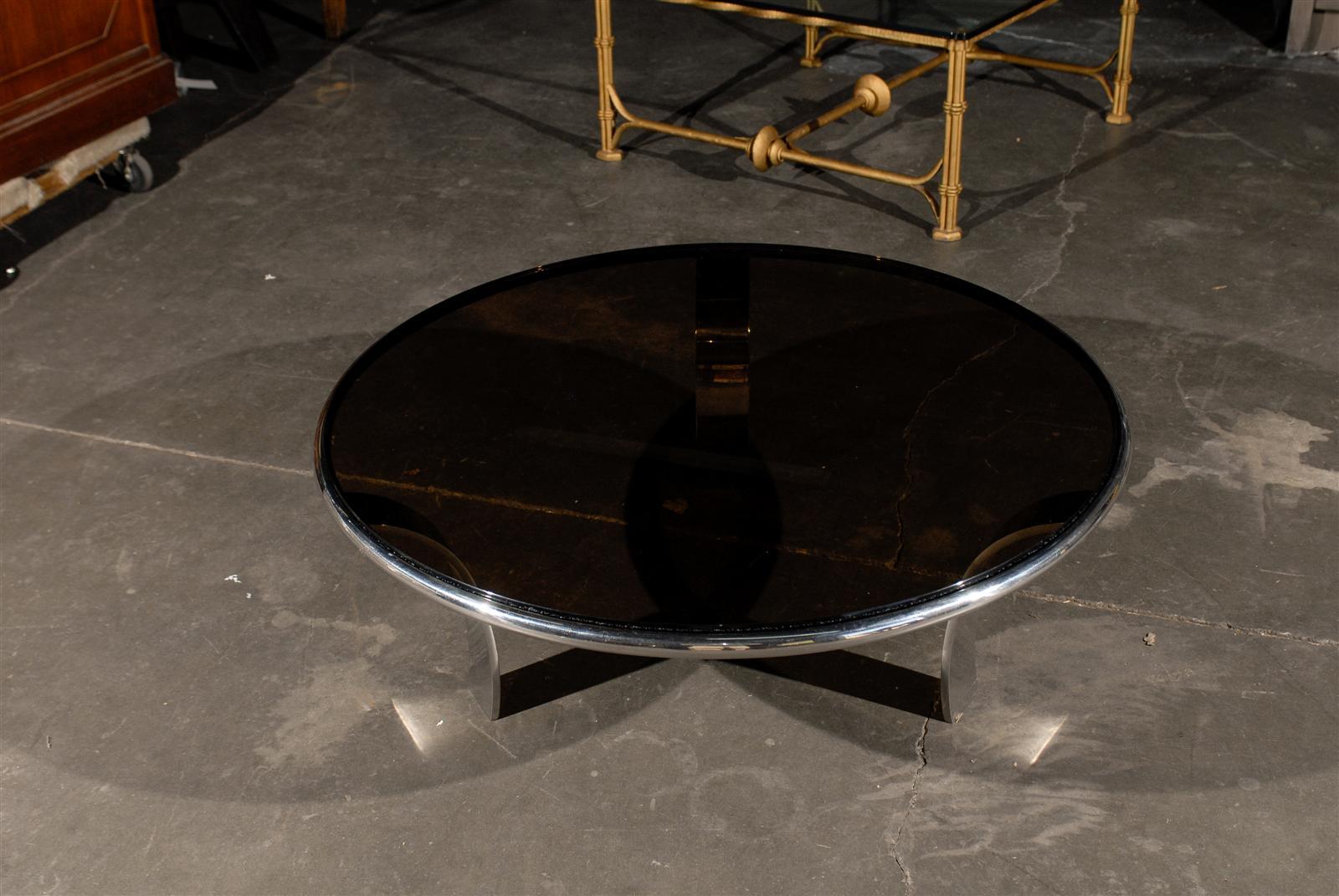 Mid-20th century round chrome coffee table with smoky glass top.